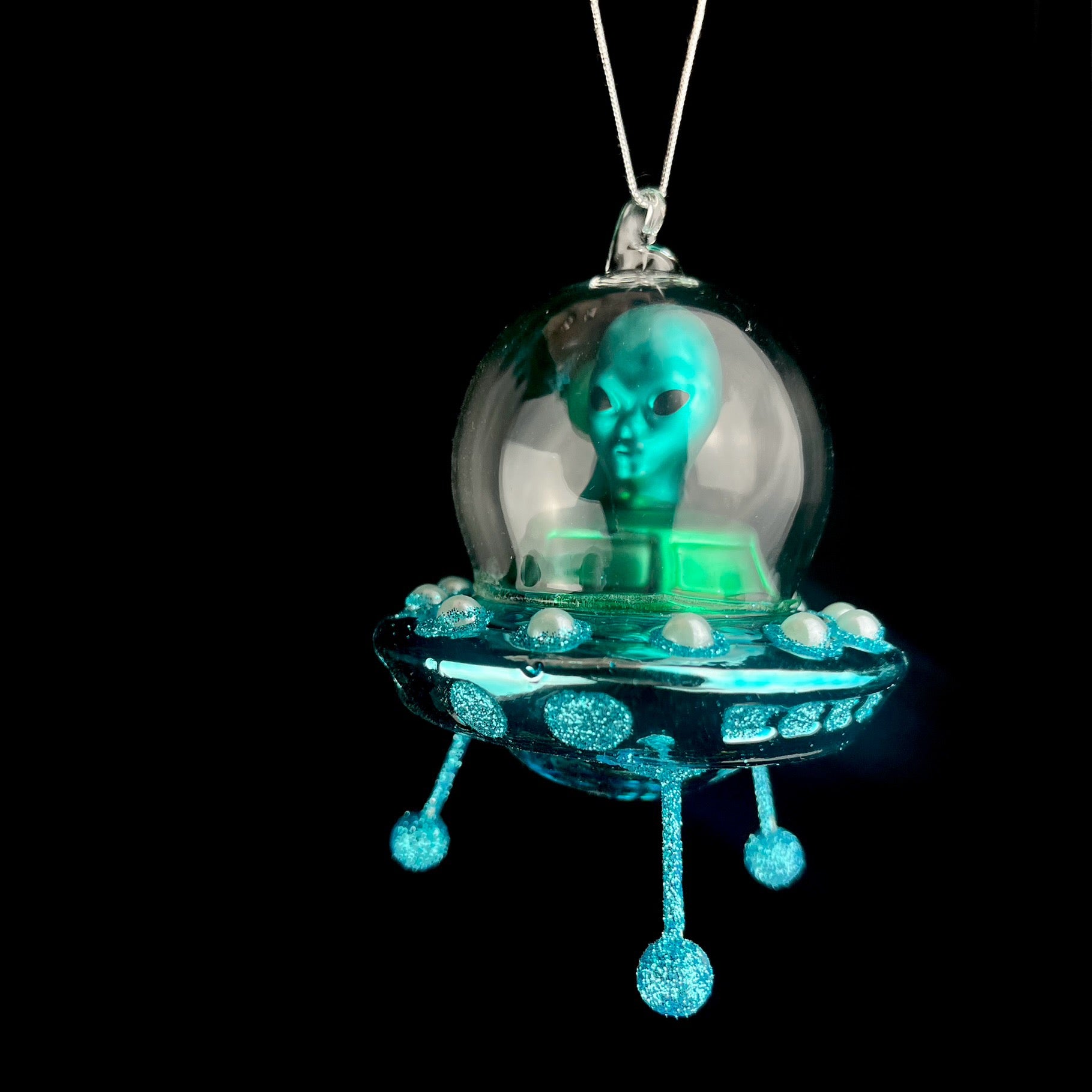 Blue Alien Spaceship floating on blackbackround