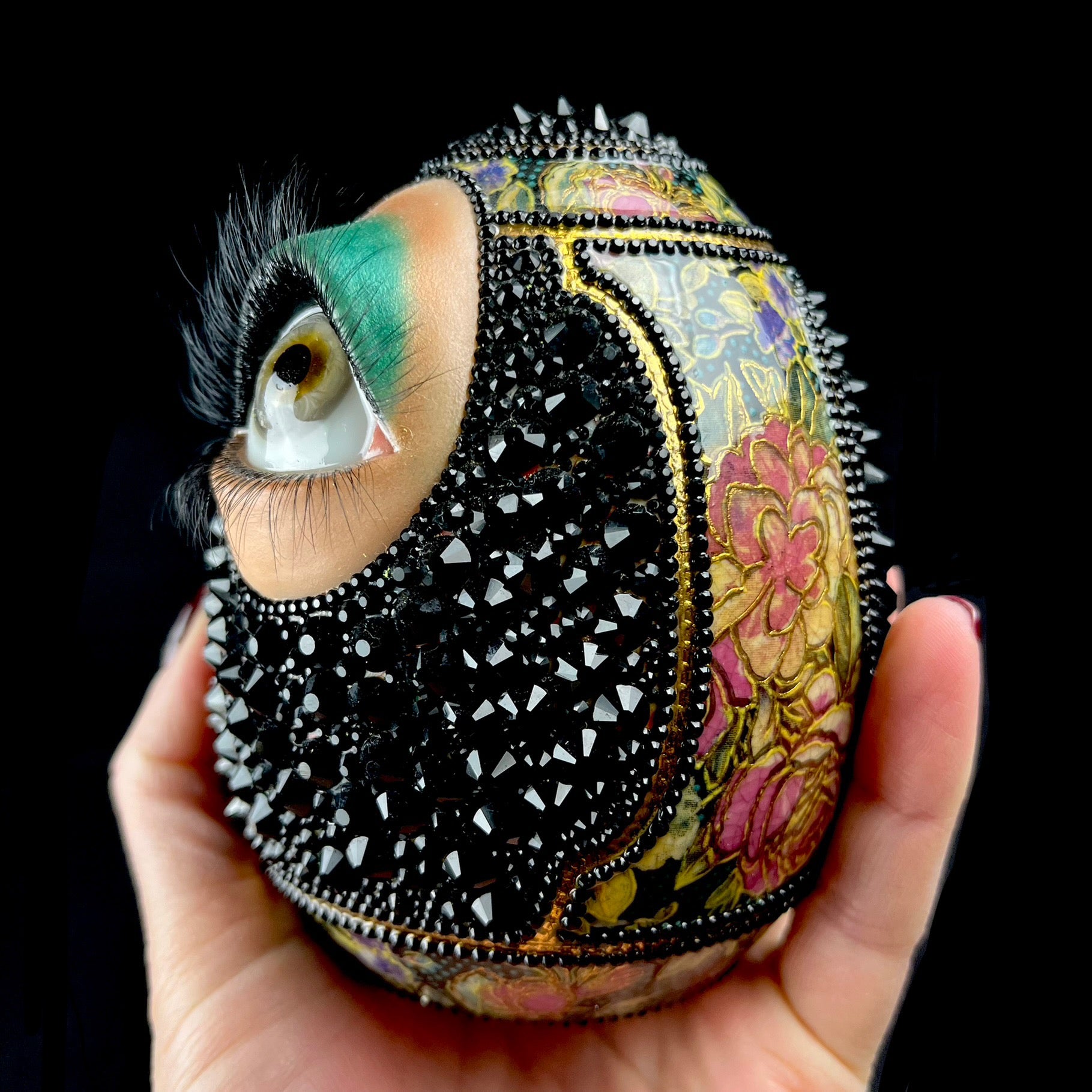 Side view of Cleo the Crystal Egg in hand