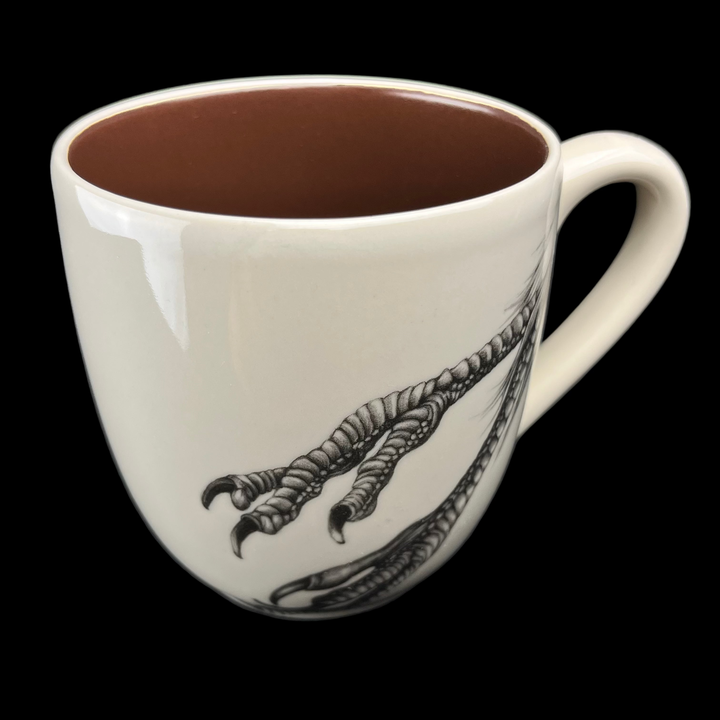 White mug with black footprints design on a dark background