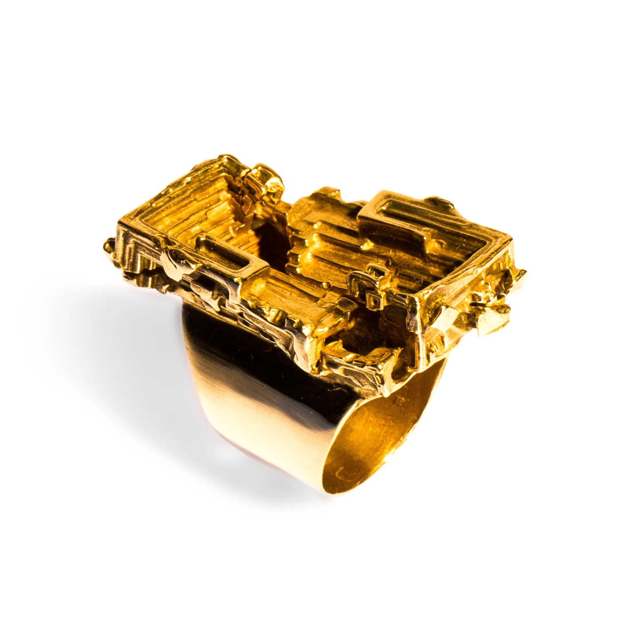 Gold ring with a textured design on a white background