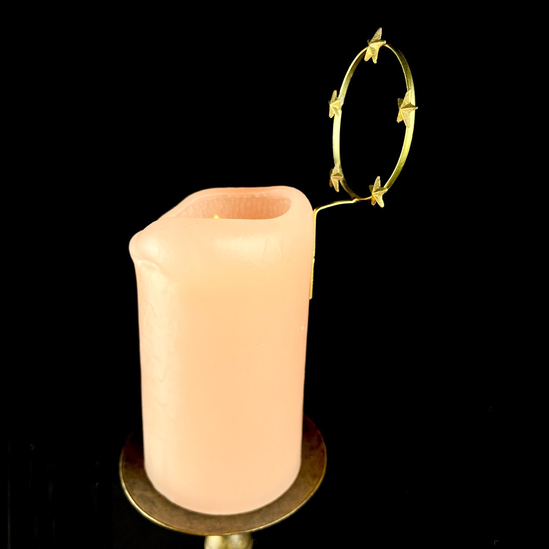 Star Halo Charm seen from side pinned into pink candle