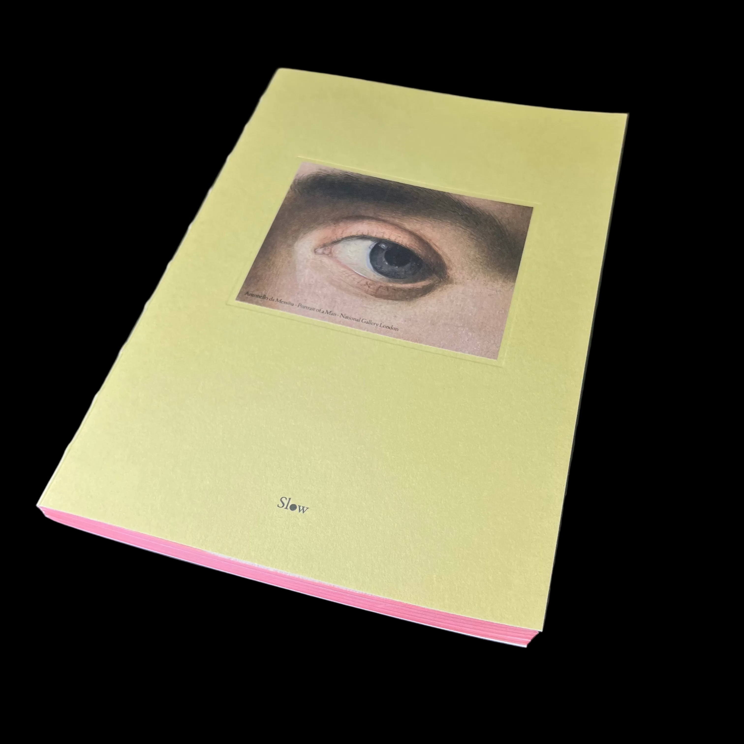 Book with an eye illustration on a dark surface