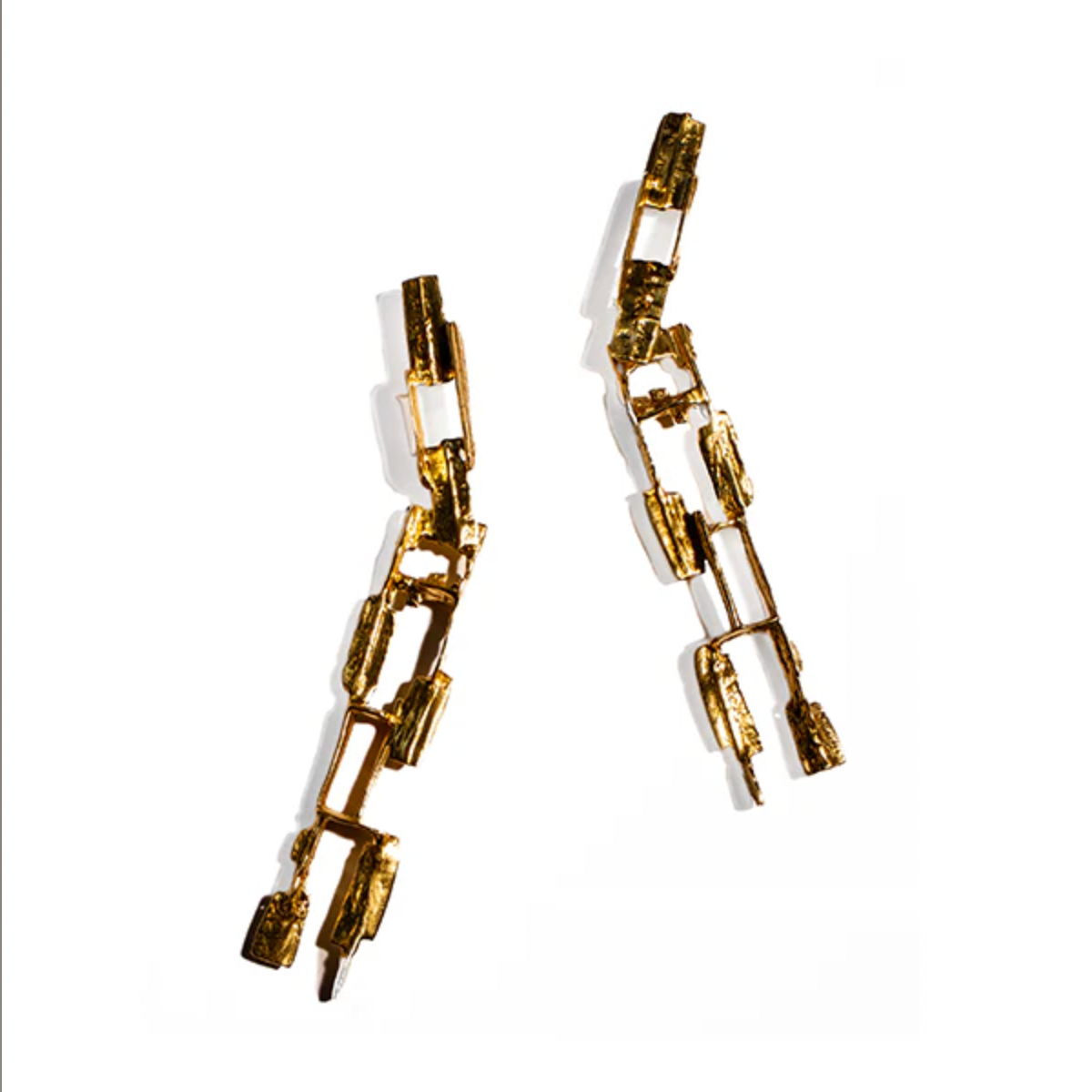 Gold chain-style earrings on a white background