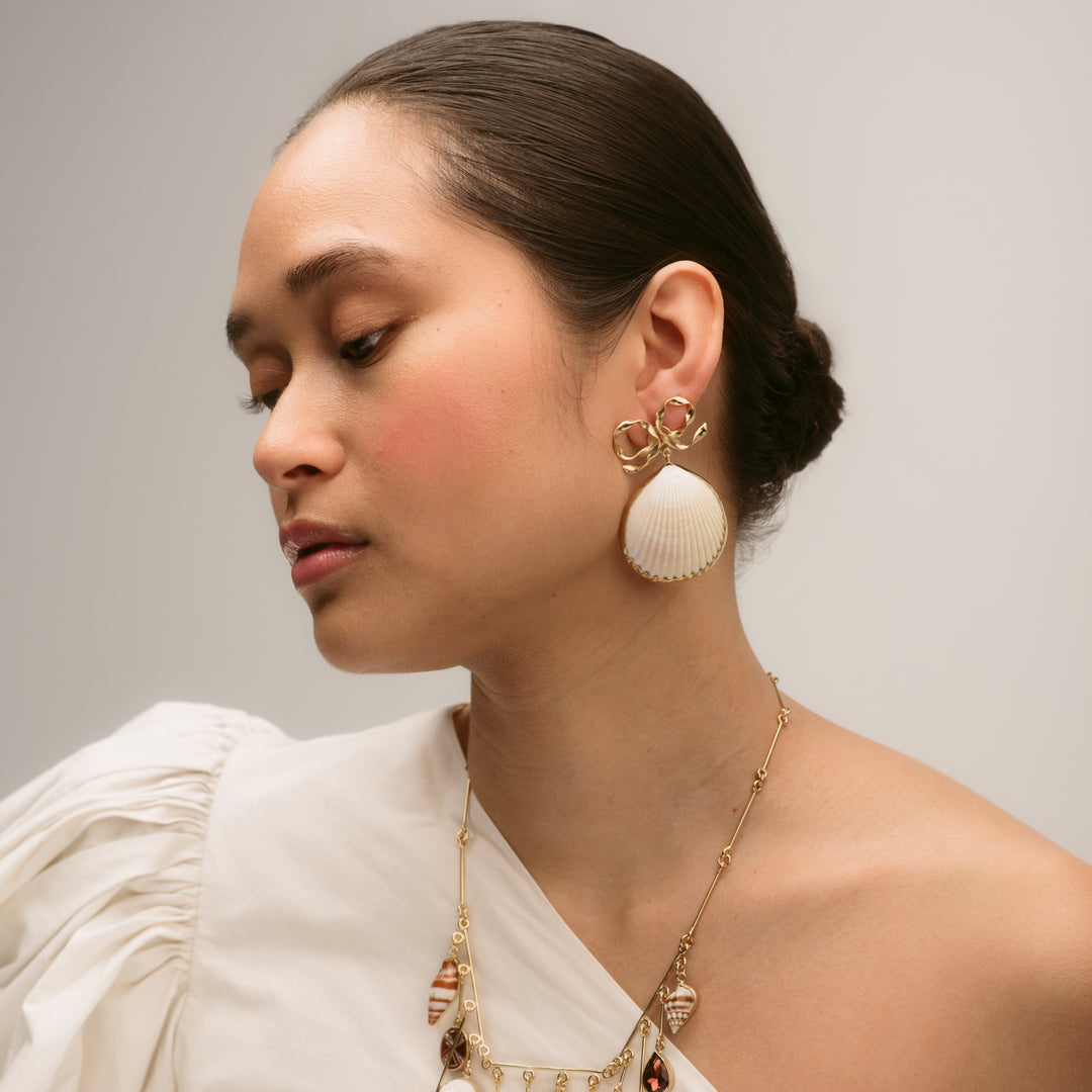 Bow and Shell Stud Earrings shown on model