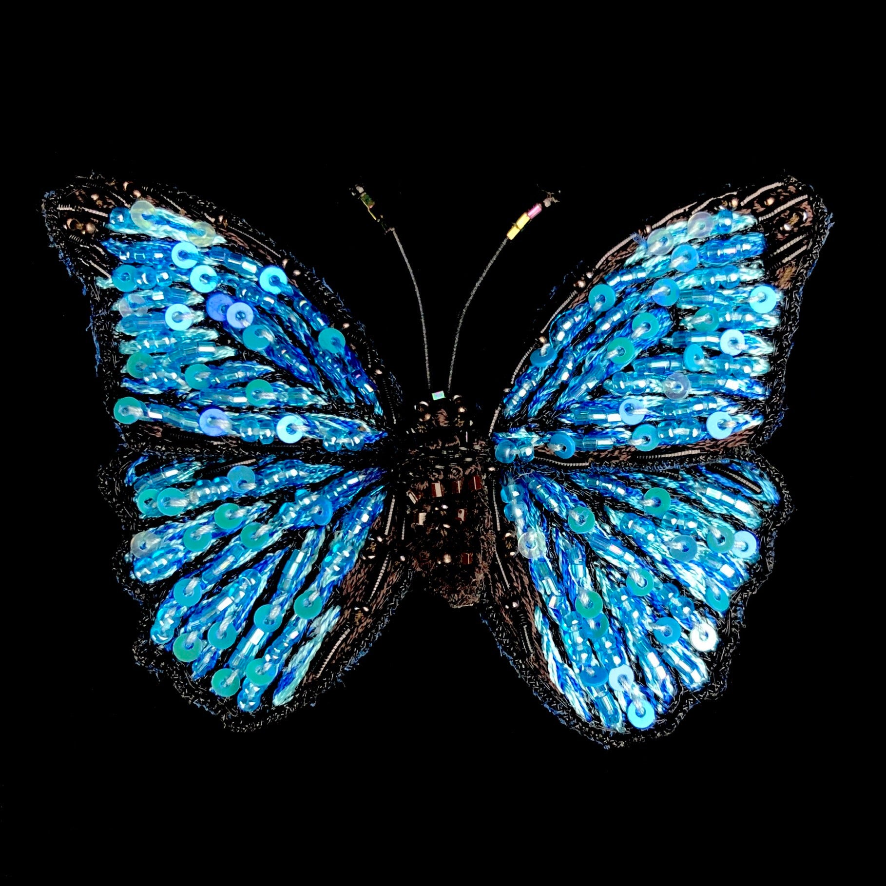 Embroidered blue and black butterfly with reflective sequins
