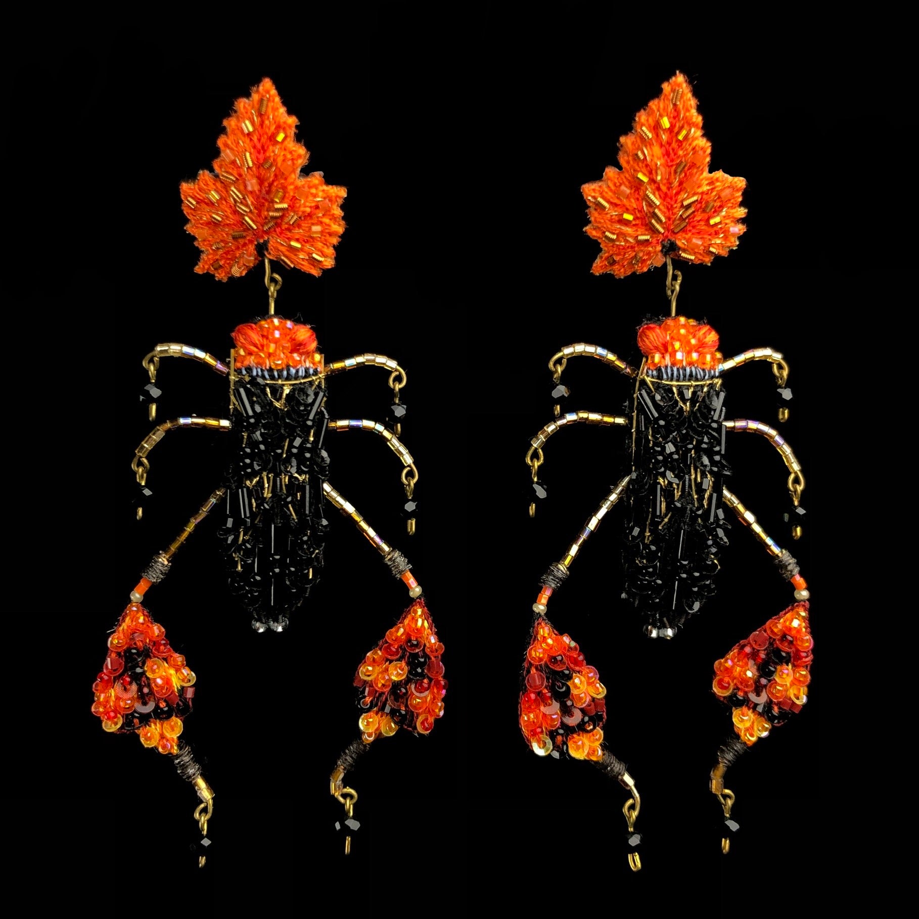 Embroidered black and orange beetles with reflective sequins and glass beads