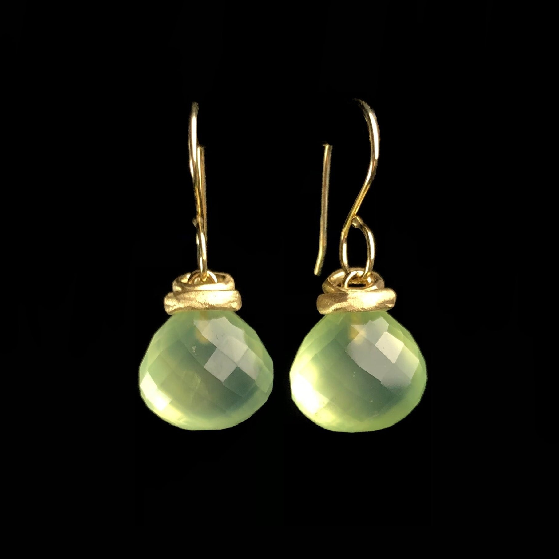 Light green translucent stones hanging from gold earring wires