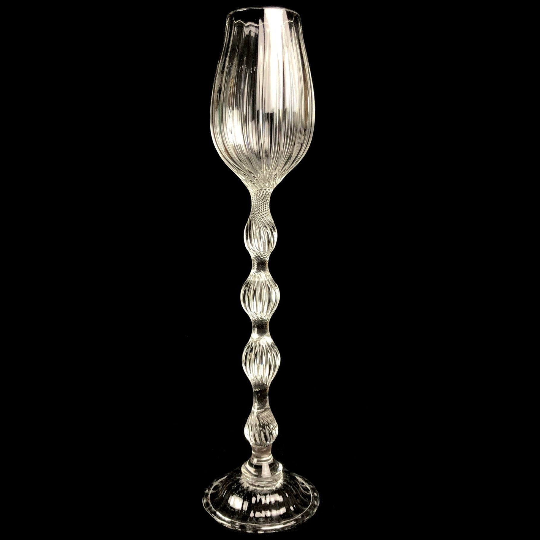 Clear glass goblet with ornate ribbing and detailed stem