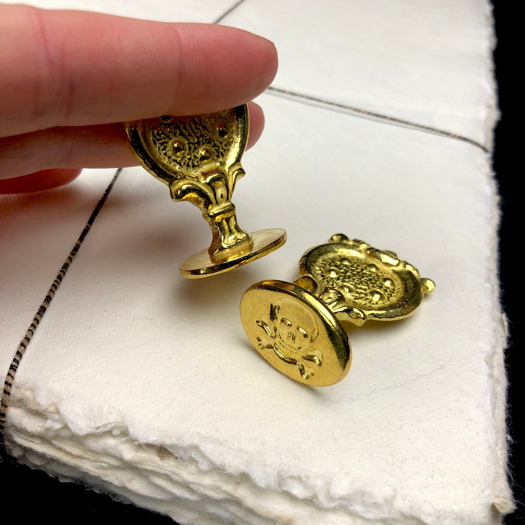 Skull and Crossbones Wax Seal shown on cotton paper