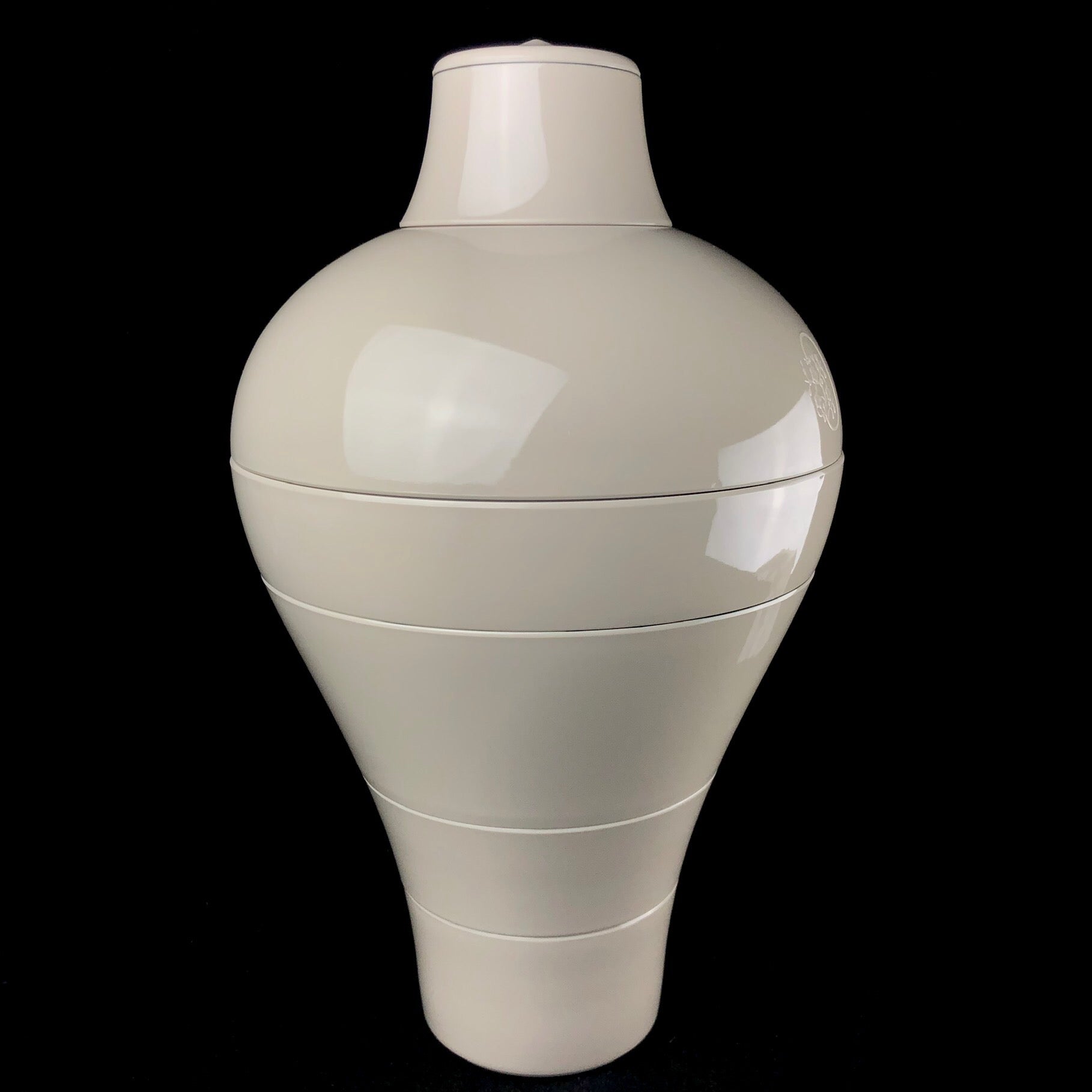 Ming Dishware set shown fully stacked in the shape of vase