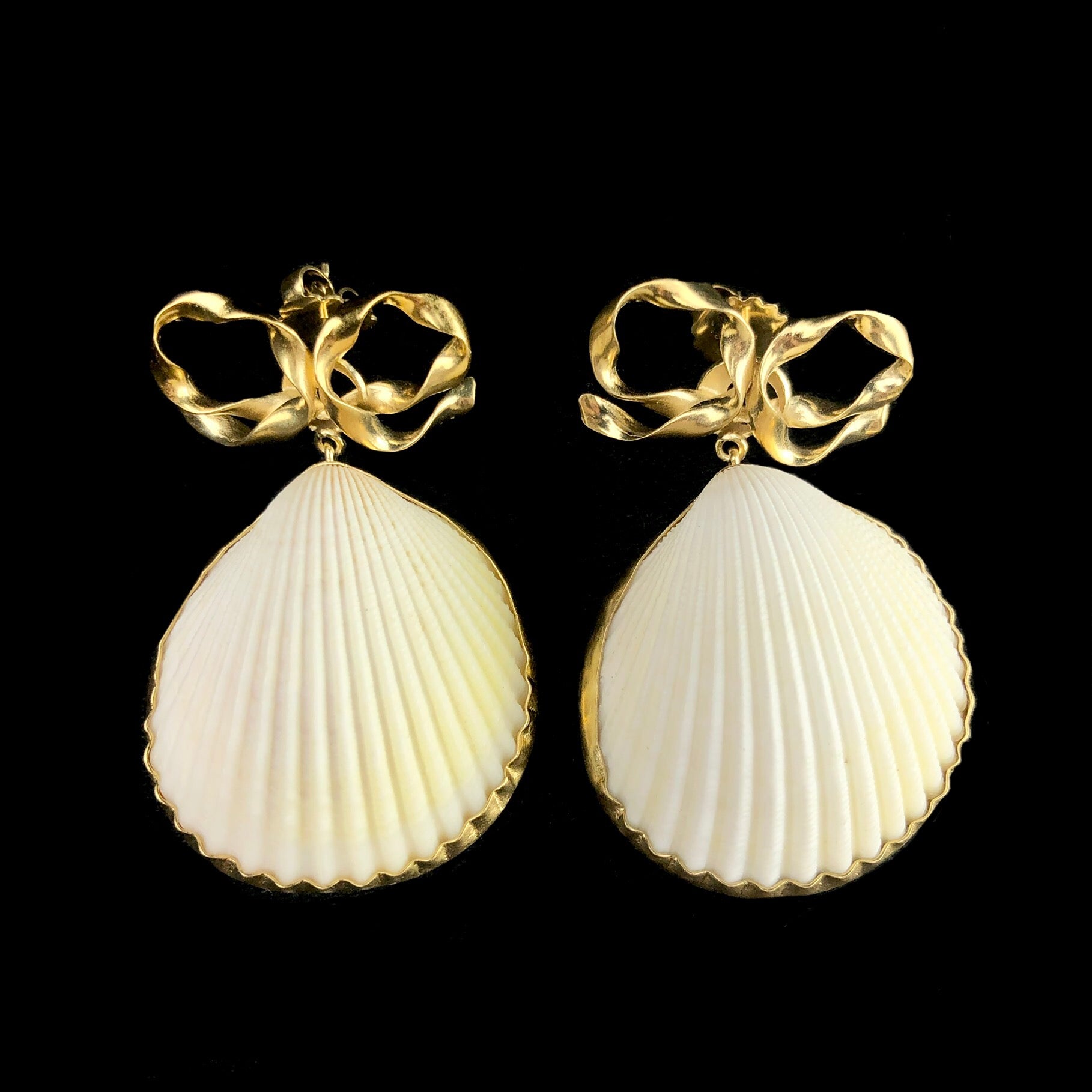 Bow and Shell Stud Earrings shown side by side