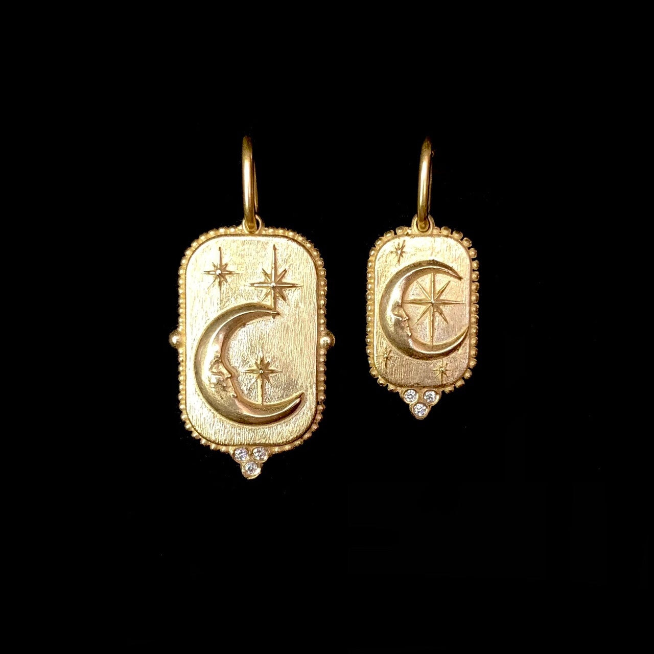 Large and Small Man in the Moon Charms side by side for size comparison