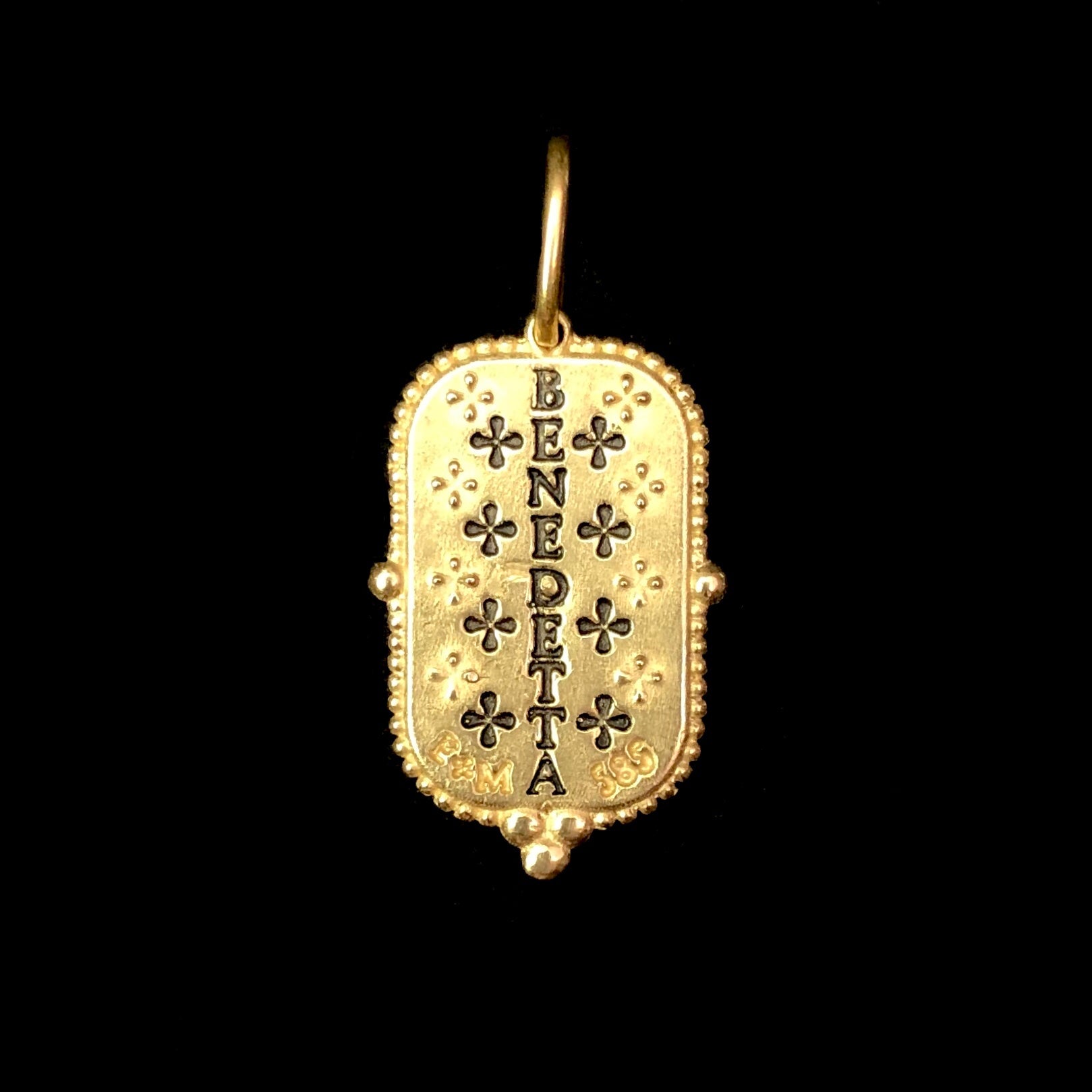 Back view of Large Man in the Moon Charm with impression of the word "benedetta" in black reading from top to bottom