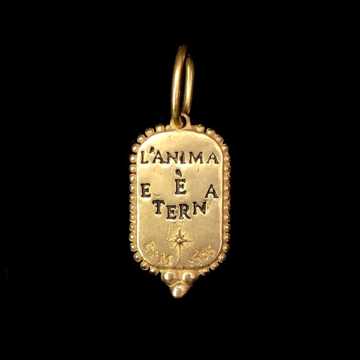 Back view of Small Man in the Moon Charm with impressed words L'ANIMA E ETERNA