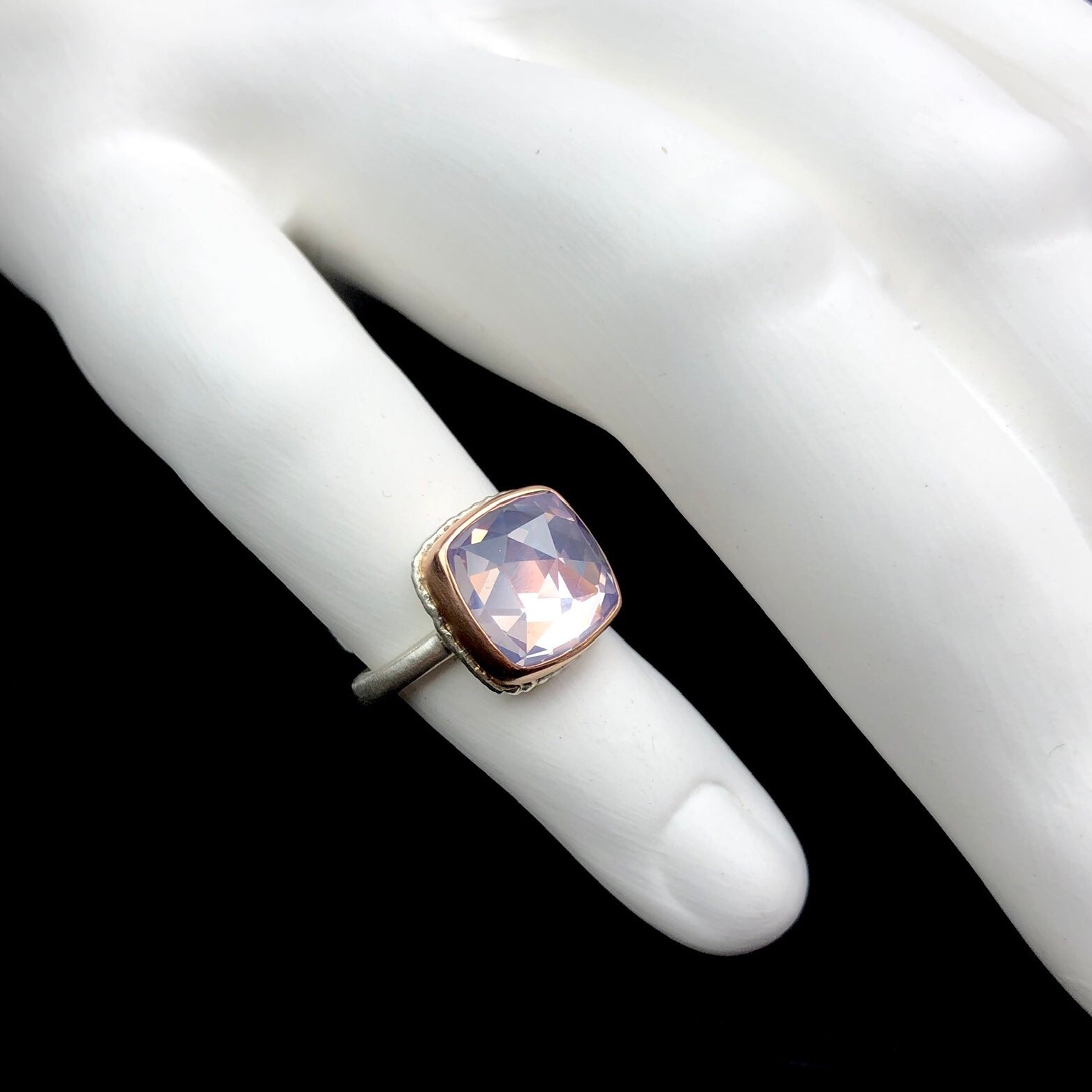 Lavender amethyst ring shown on white ceramic finger