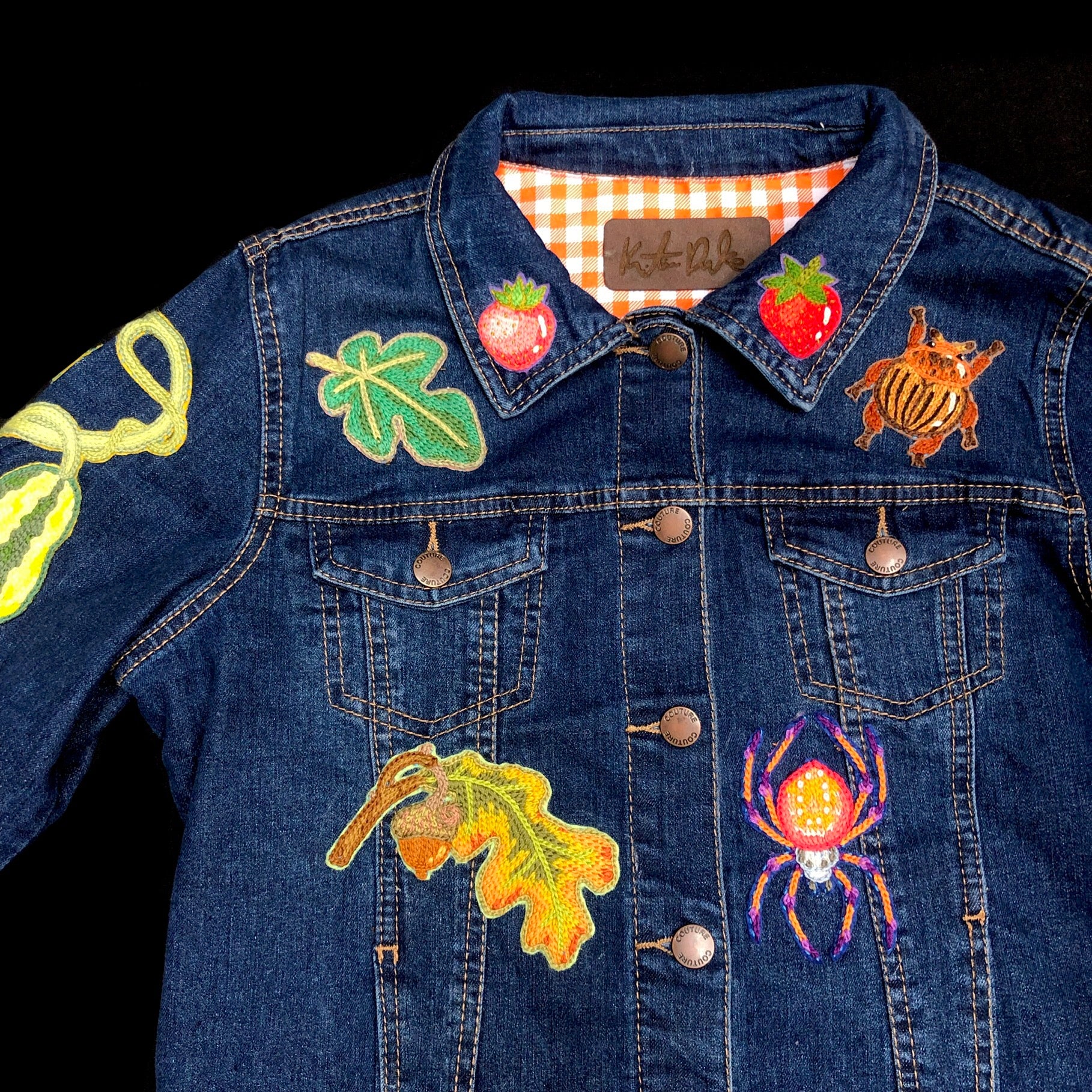 Closer view of patches on the front of jacket with Kristina Drake signature tag