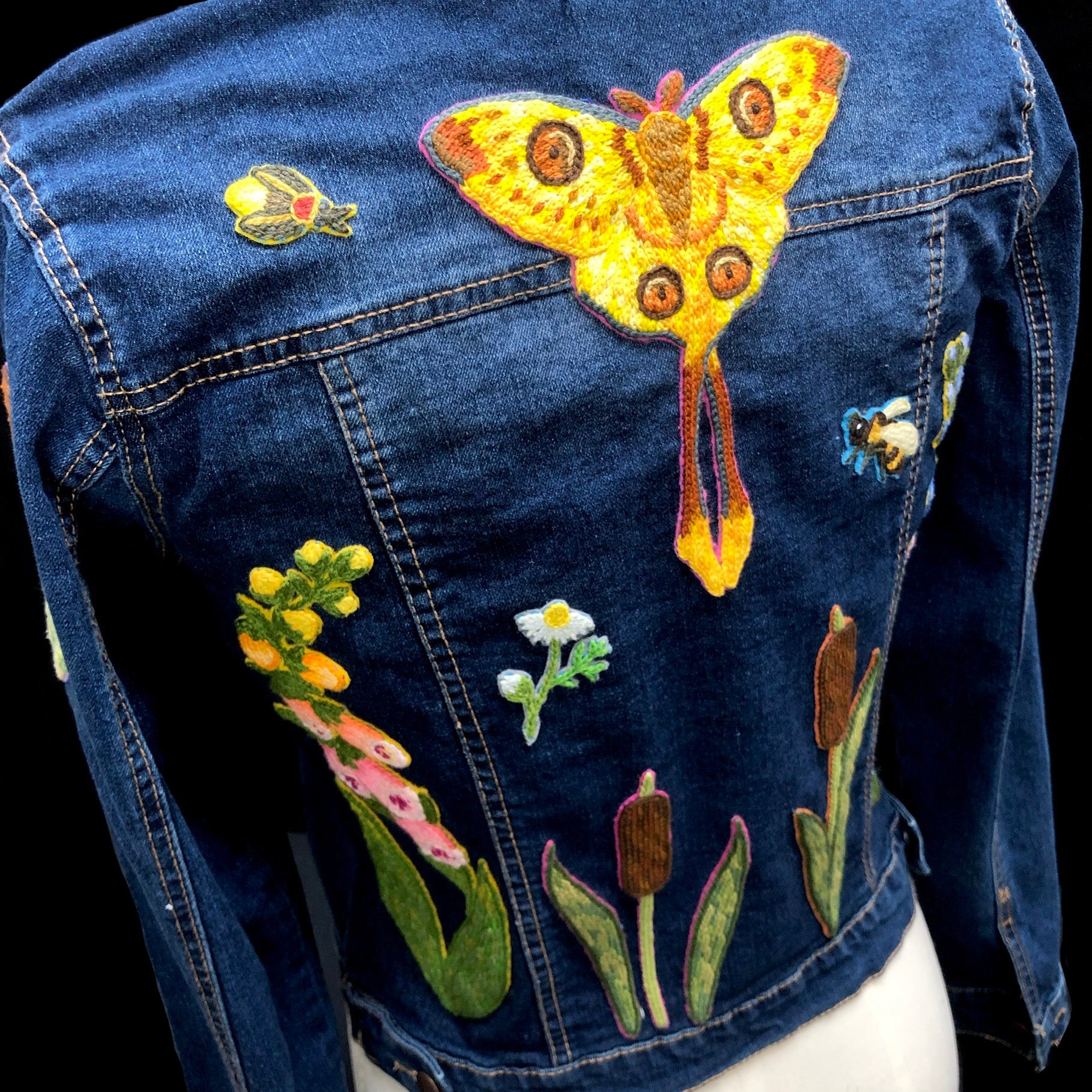 Detail view of comet moth patch on back of jacket