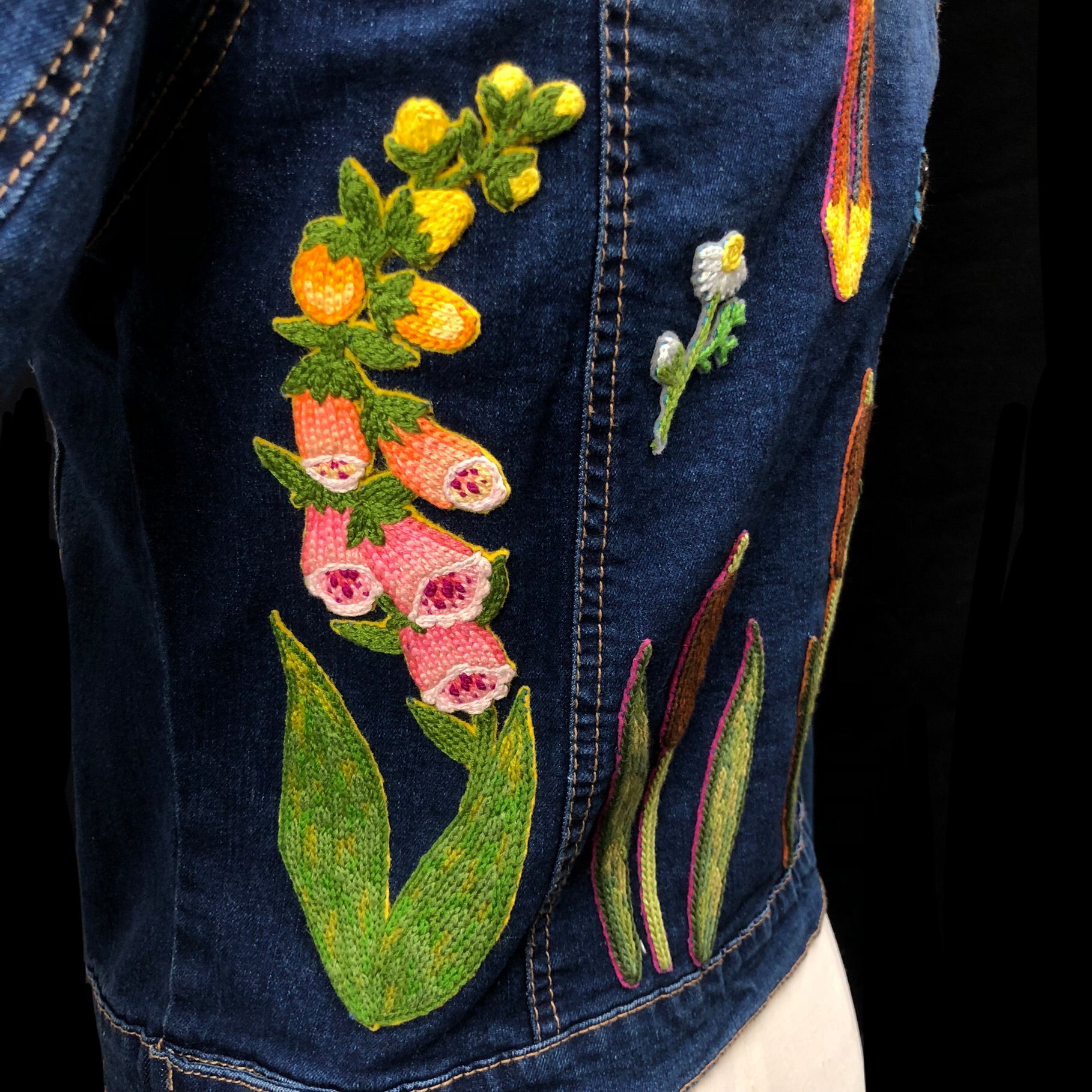 Detail view of pink, orange and yellow foxglove flower patch