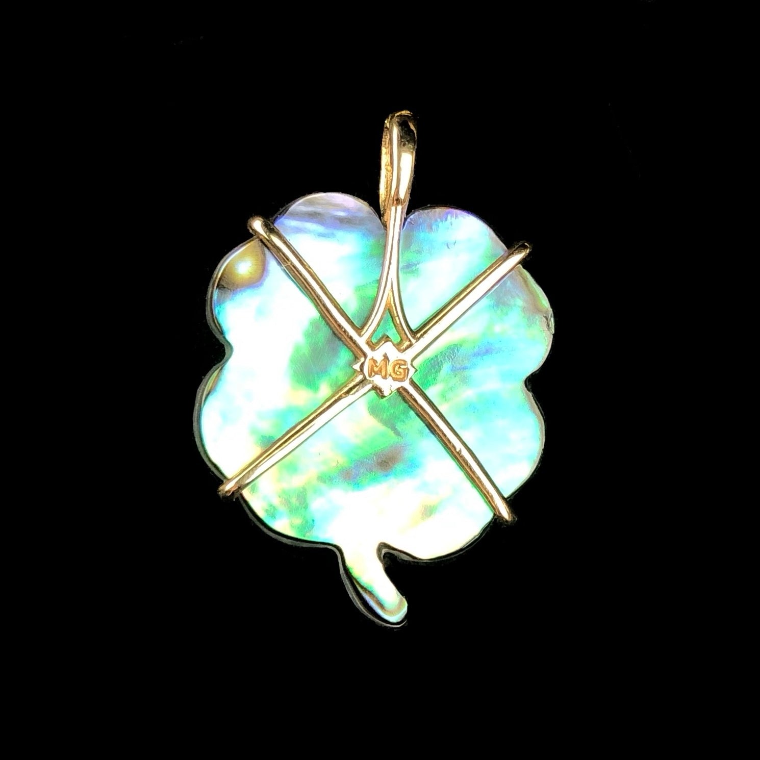 Back view of Luminescent Clover Charm set in 14K gold with artist's initials MG