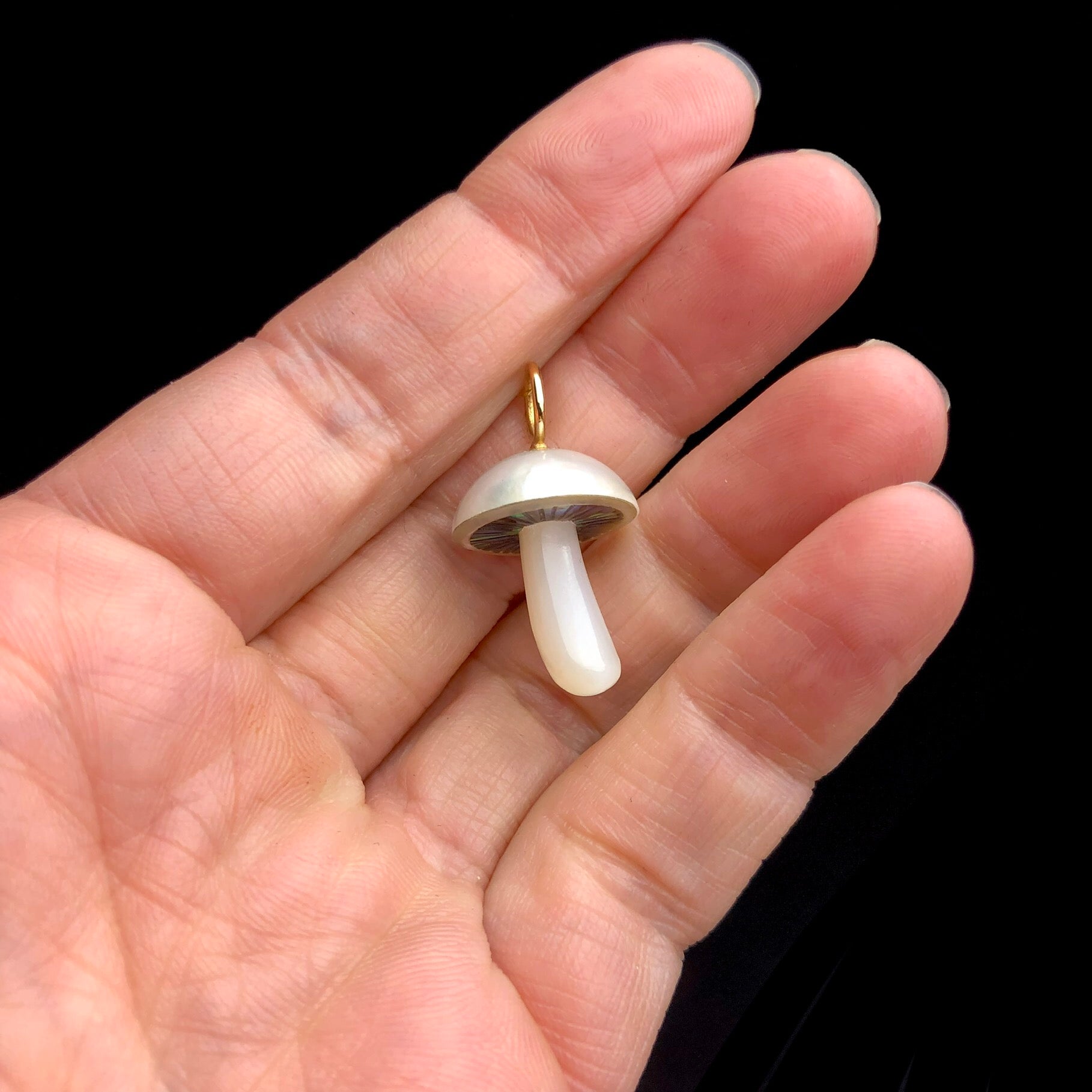 Mother of Pearl Mushroom Charm shown in hand