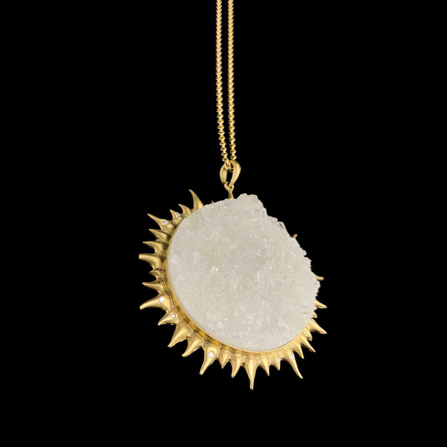 Detail view of crystalline surface and gold setting of Sun and Moon Necklace
