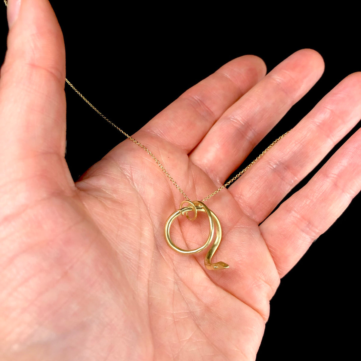 Gold Snake Necklace shown in hand
