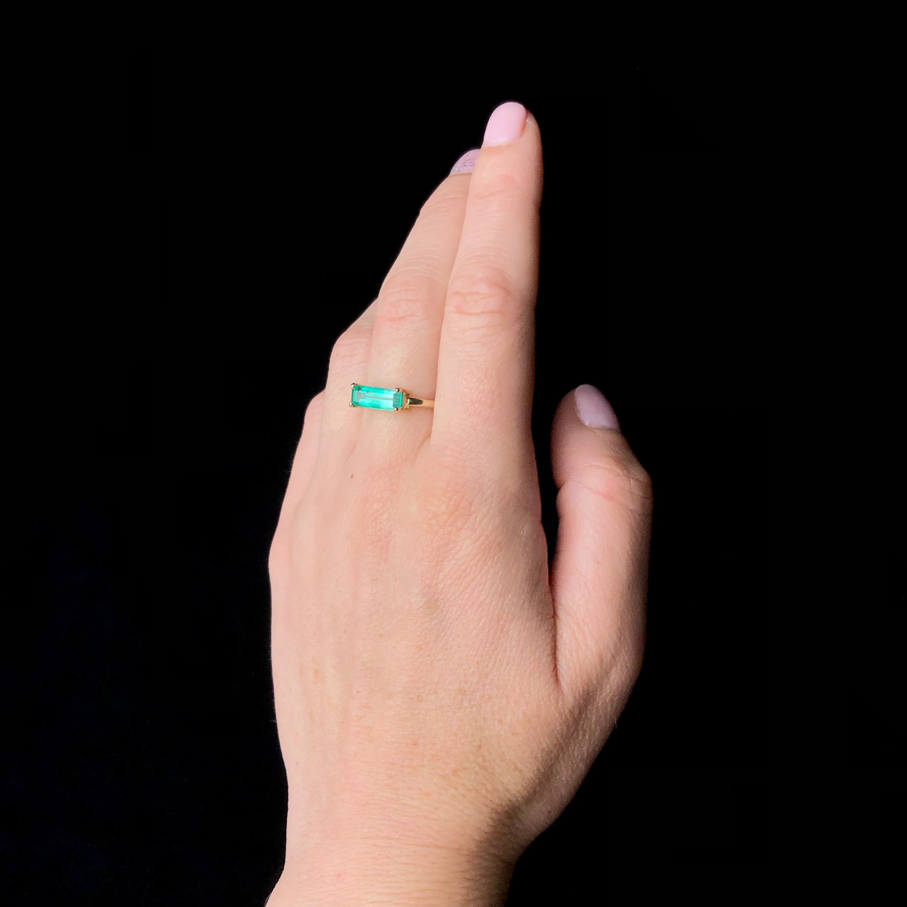 Rectangular Emerald Gold Ring shown worn on hand