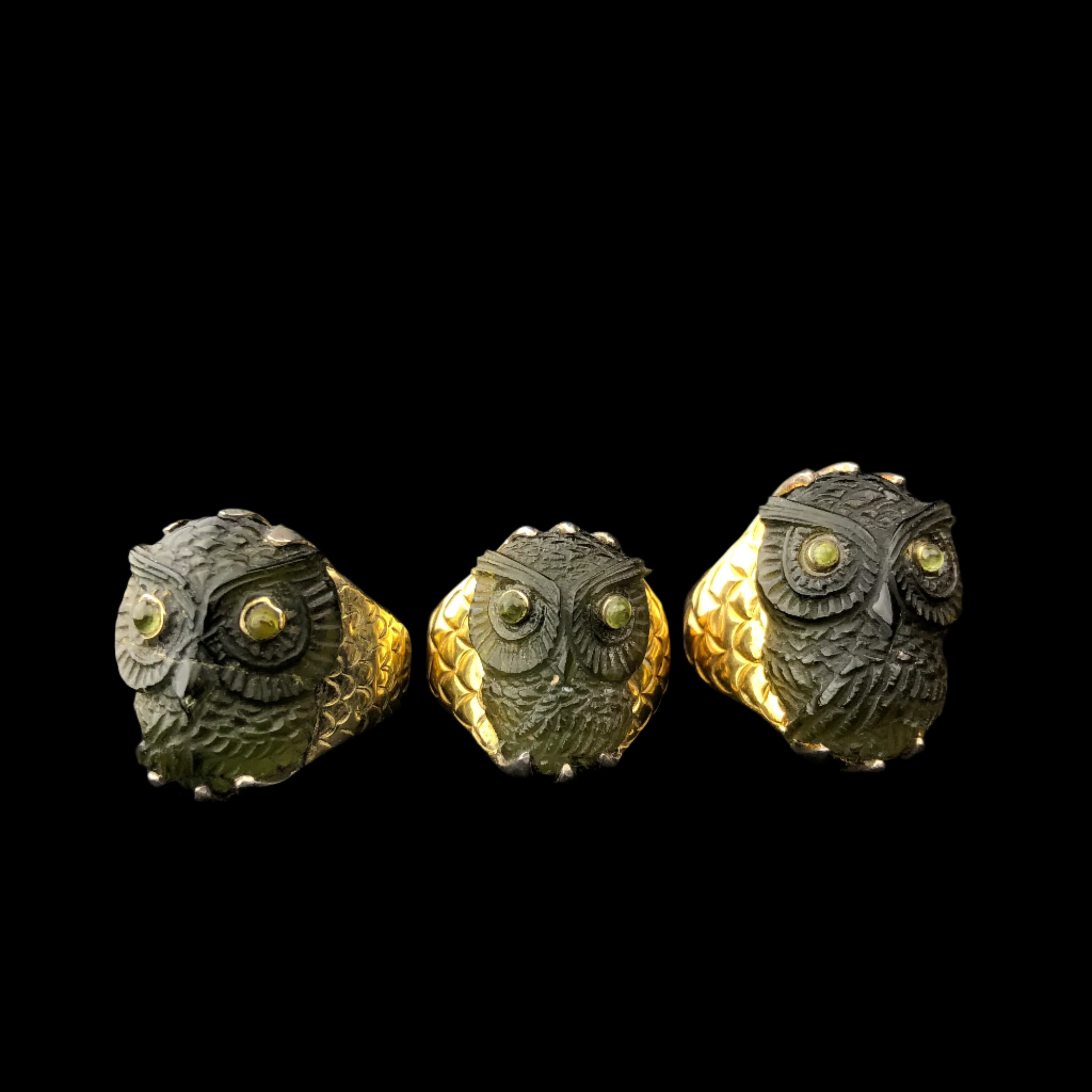 Three moldavite owl rings in a row