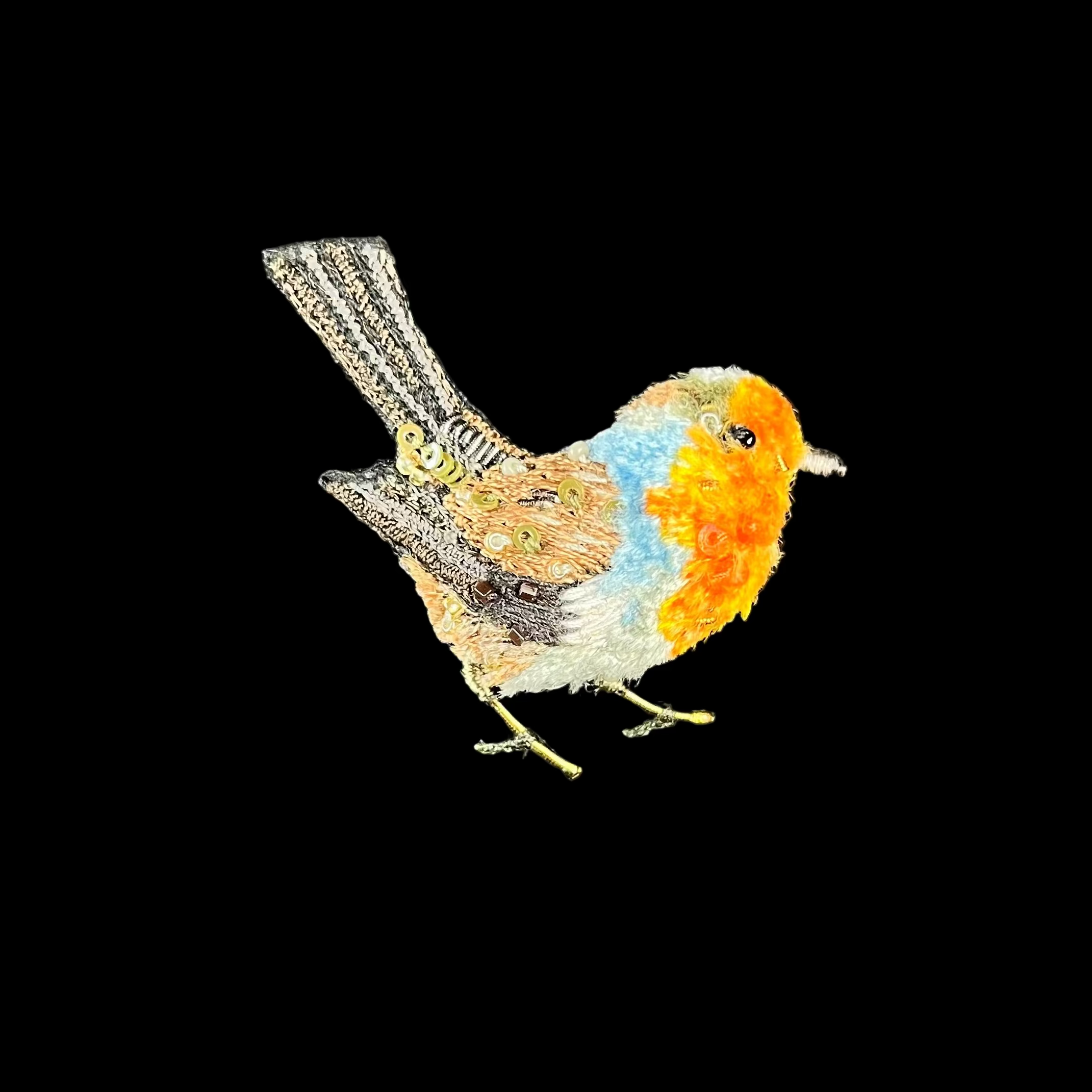 Embroidered patch of a robin on a black background