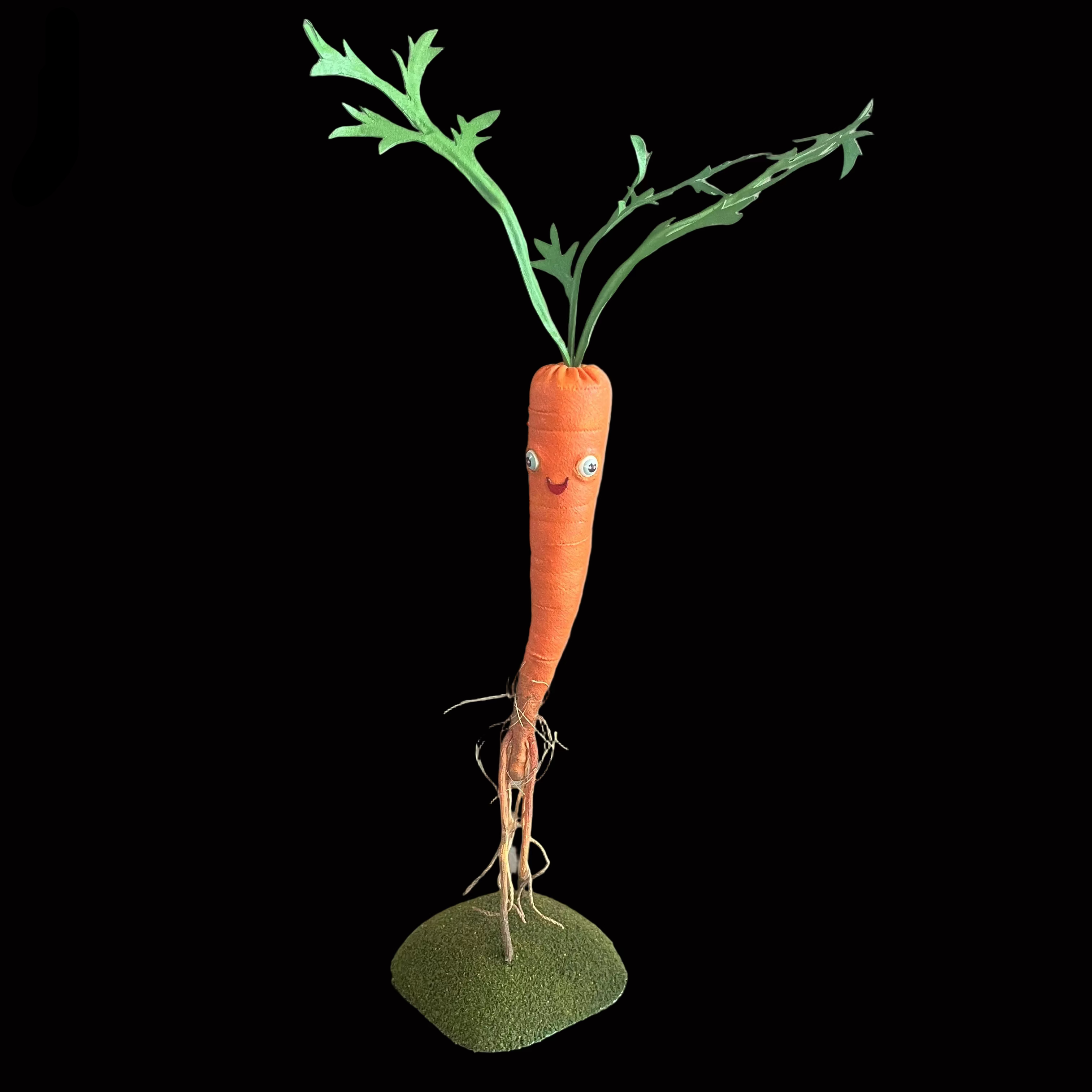 Whimsical carrot-shaped decorative figure standing on green turf base set against black background.