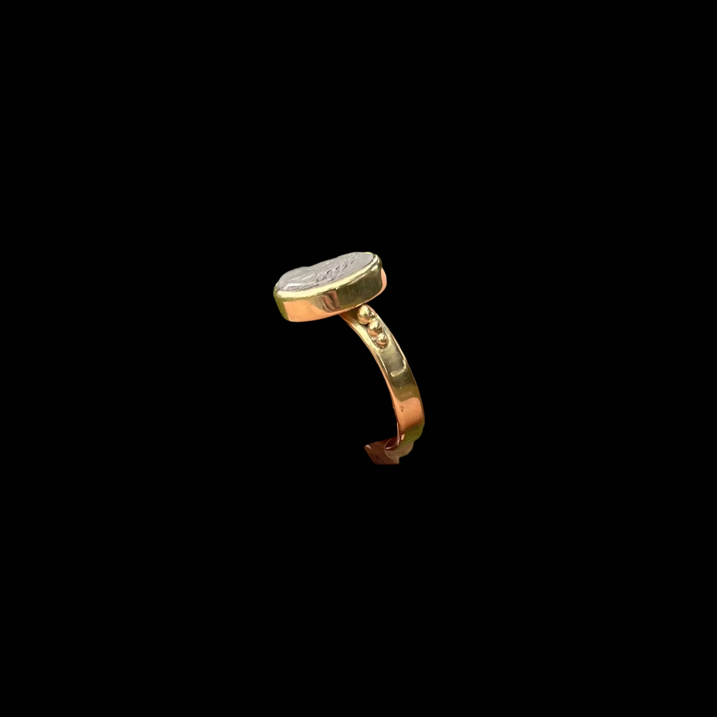 Gold ring side view on black background