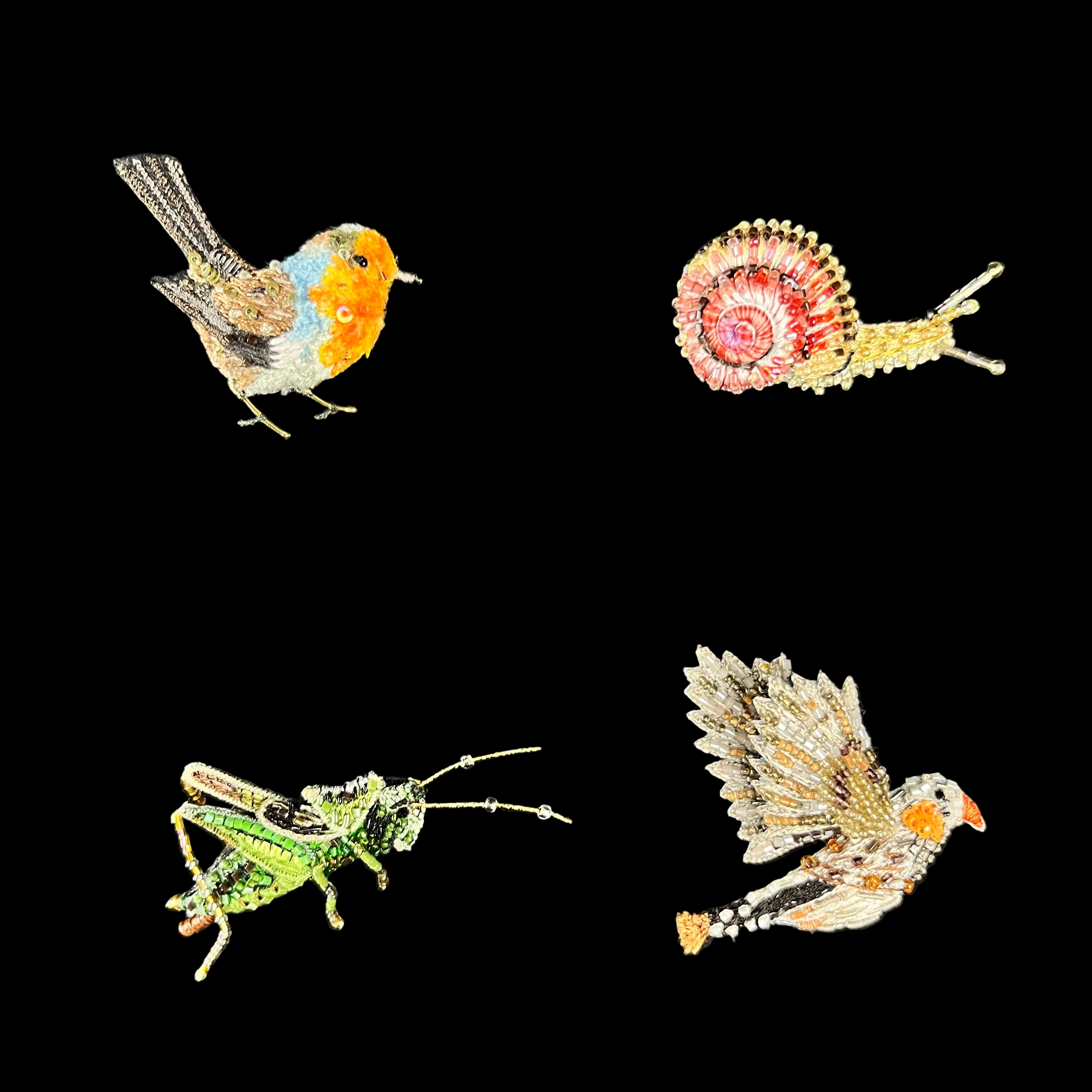 Four embroidered insect pins on black card backing