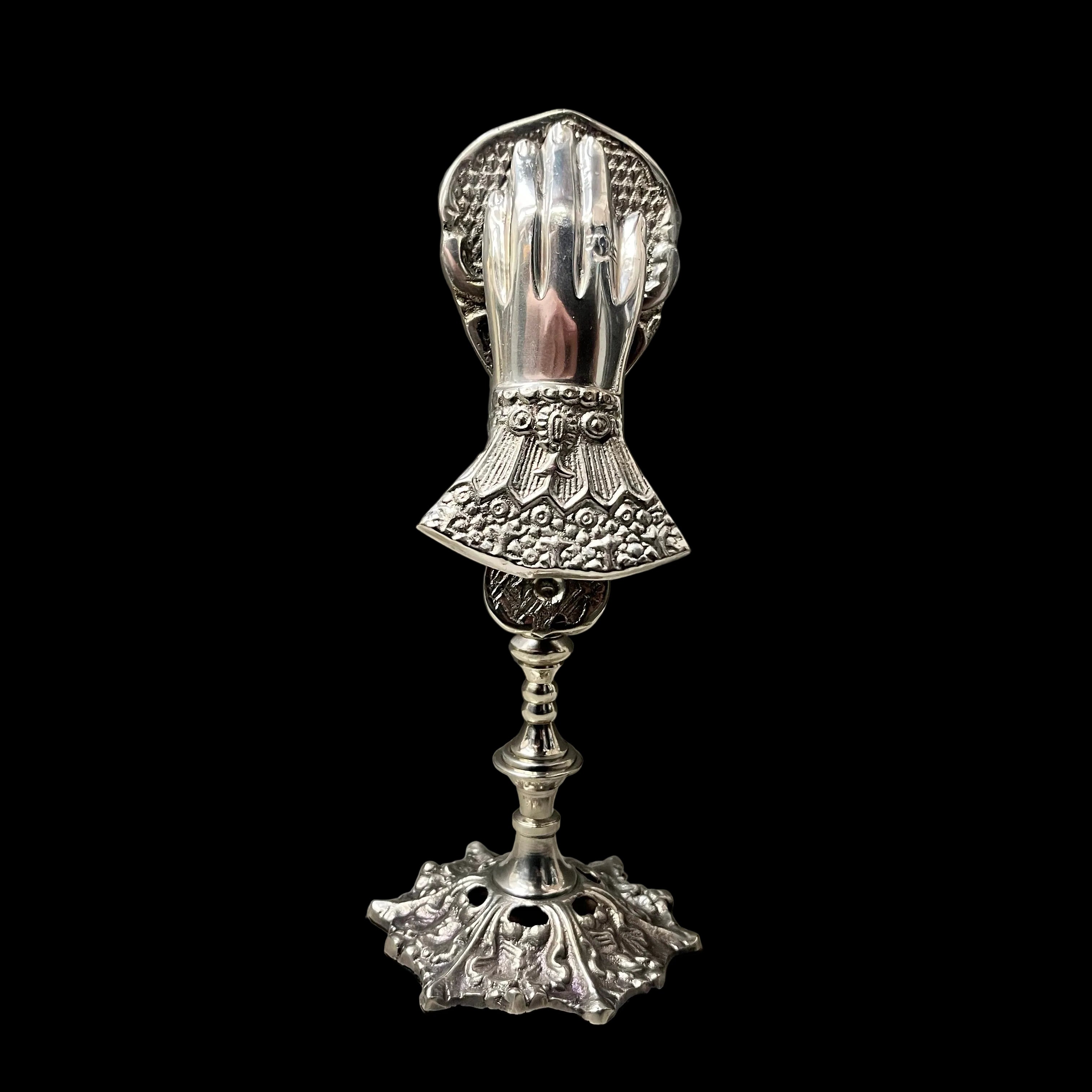 Decorative silver candle holder on a gray background