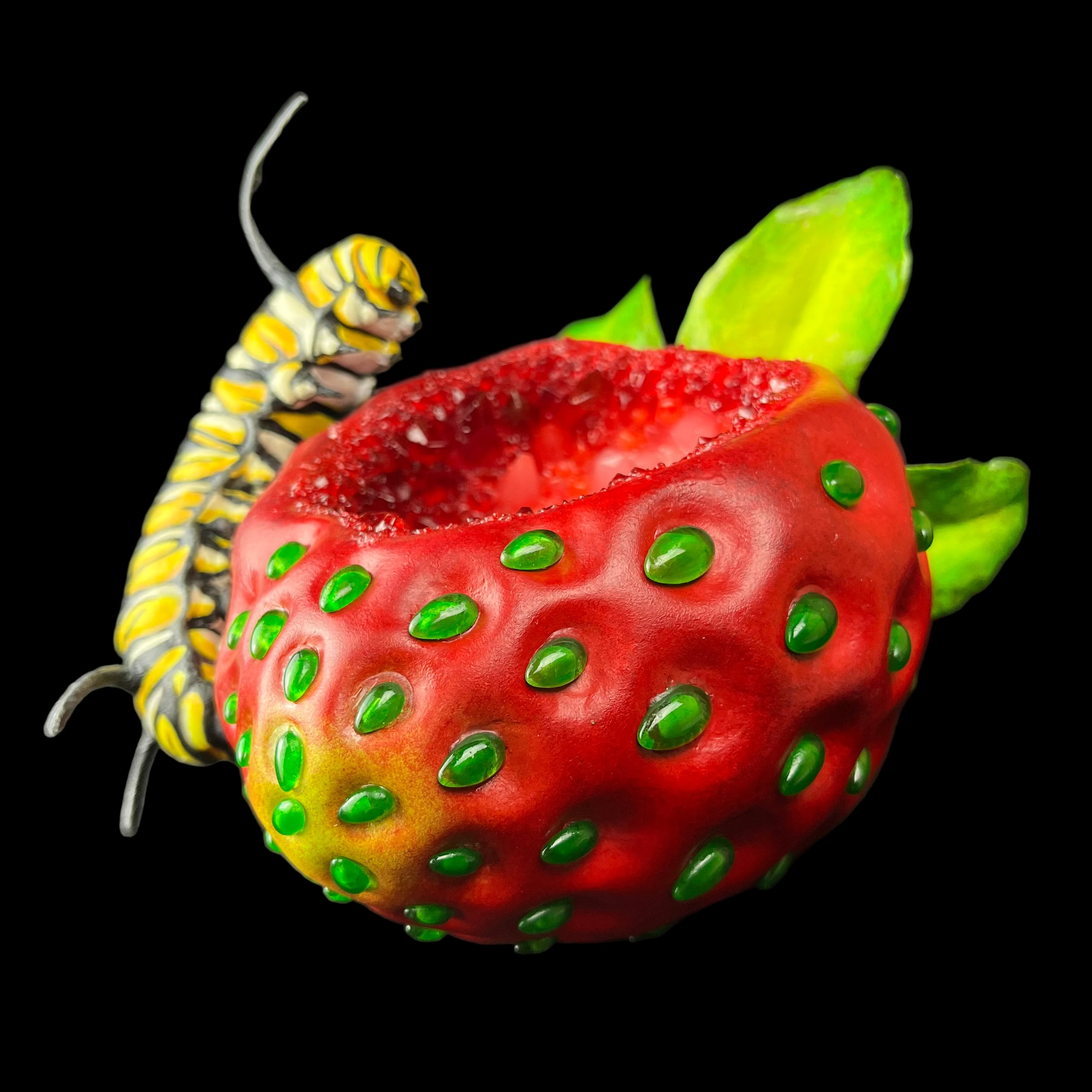 Strawberry with green seeds and a caterpillar on a black background