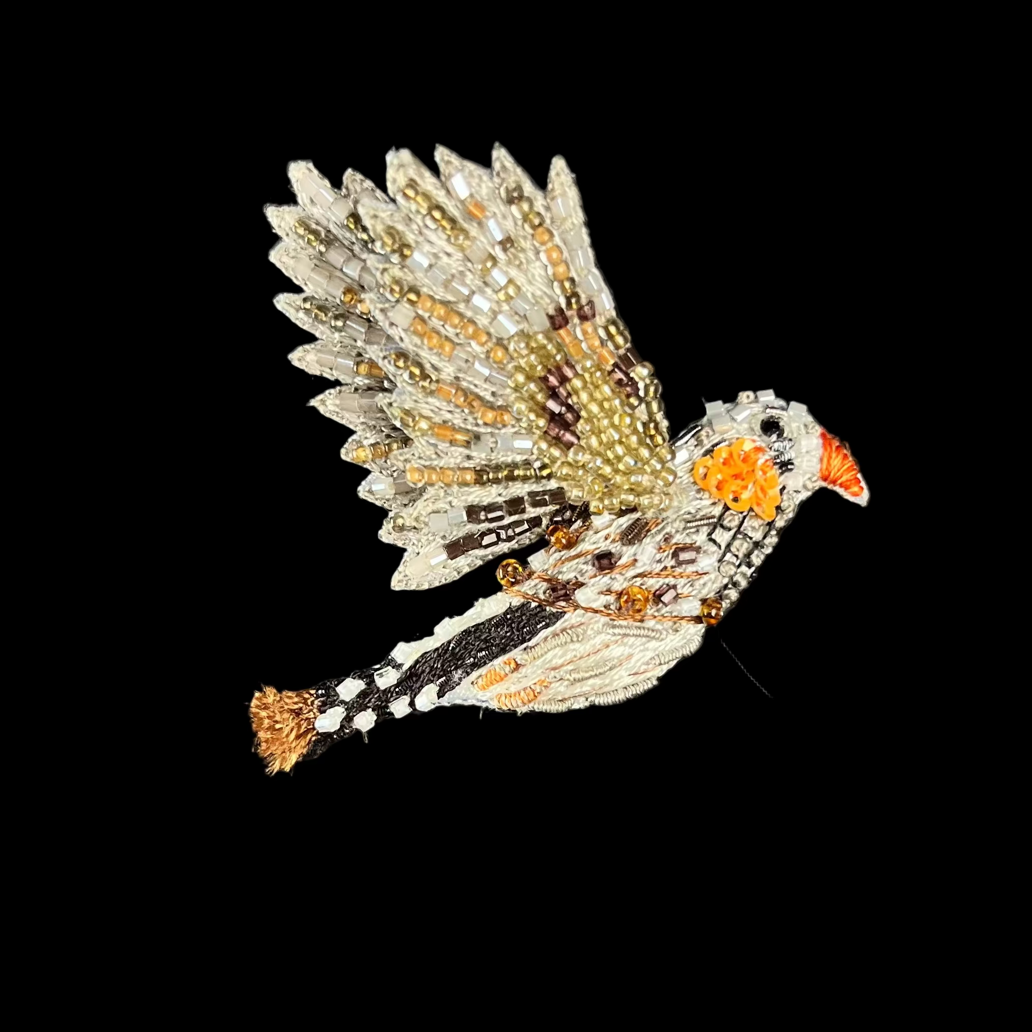 Decorative bird brooch on a black background
