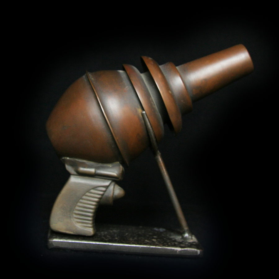 Side view of copper Ray Gun art object on stand