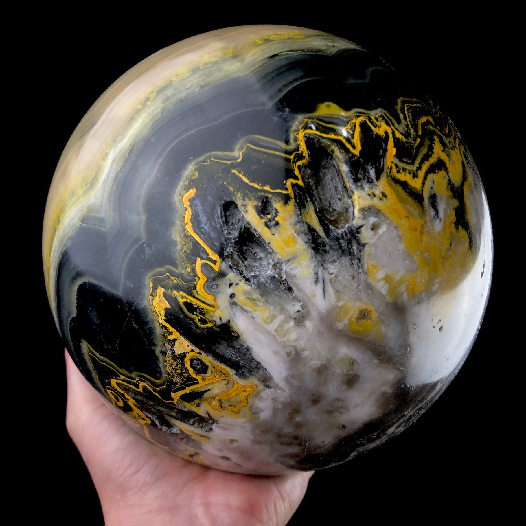 Bumblebee Jasper Stone Sphere shown in hand