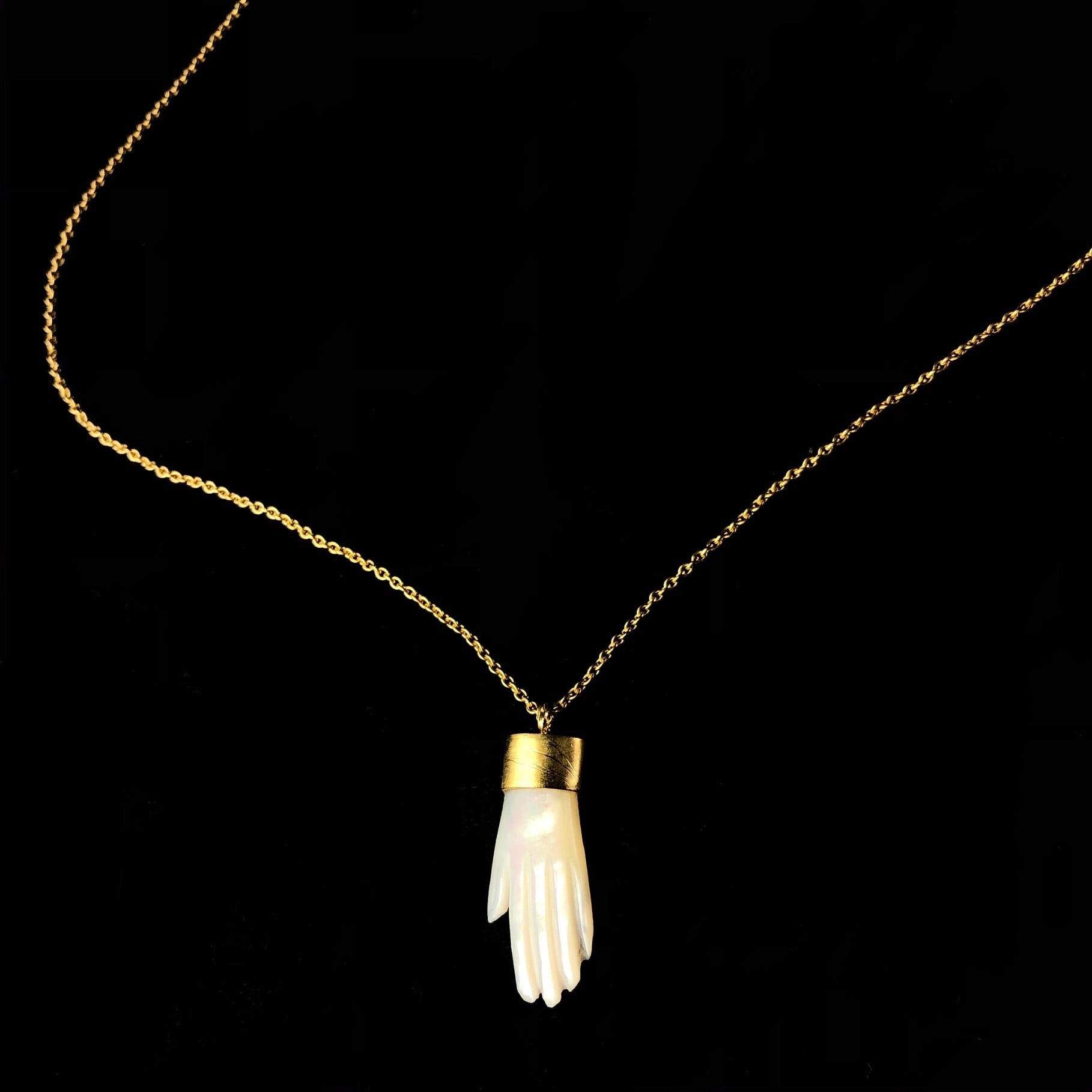 Detail view of White Mother of Pearl Hand charm on chain