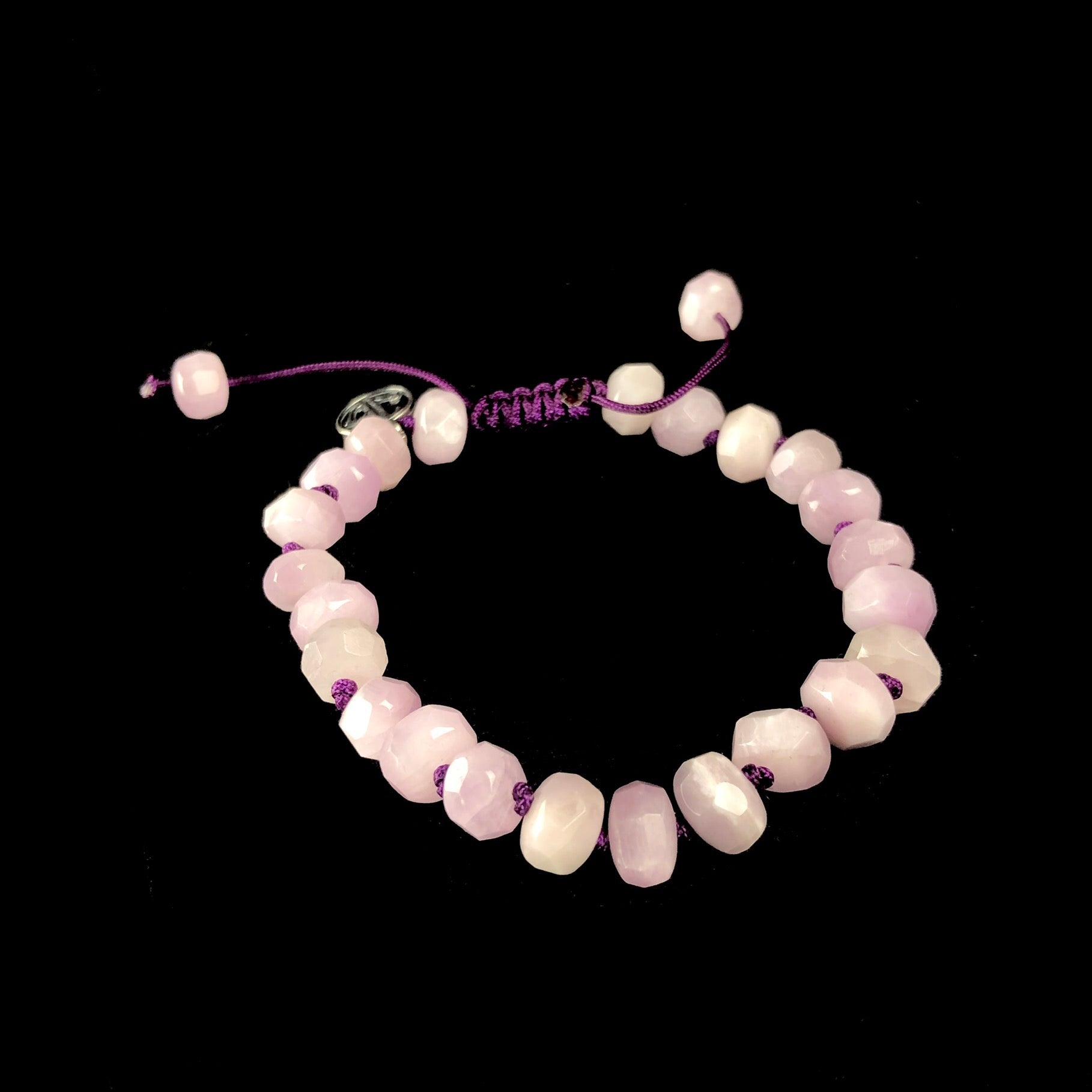 Light pink faceted stone bracelet with dark purple knitted string