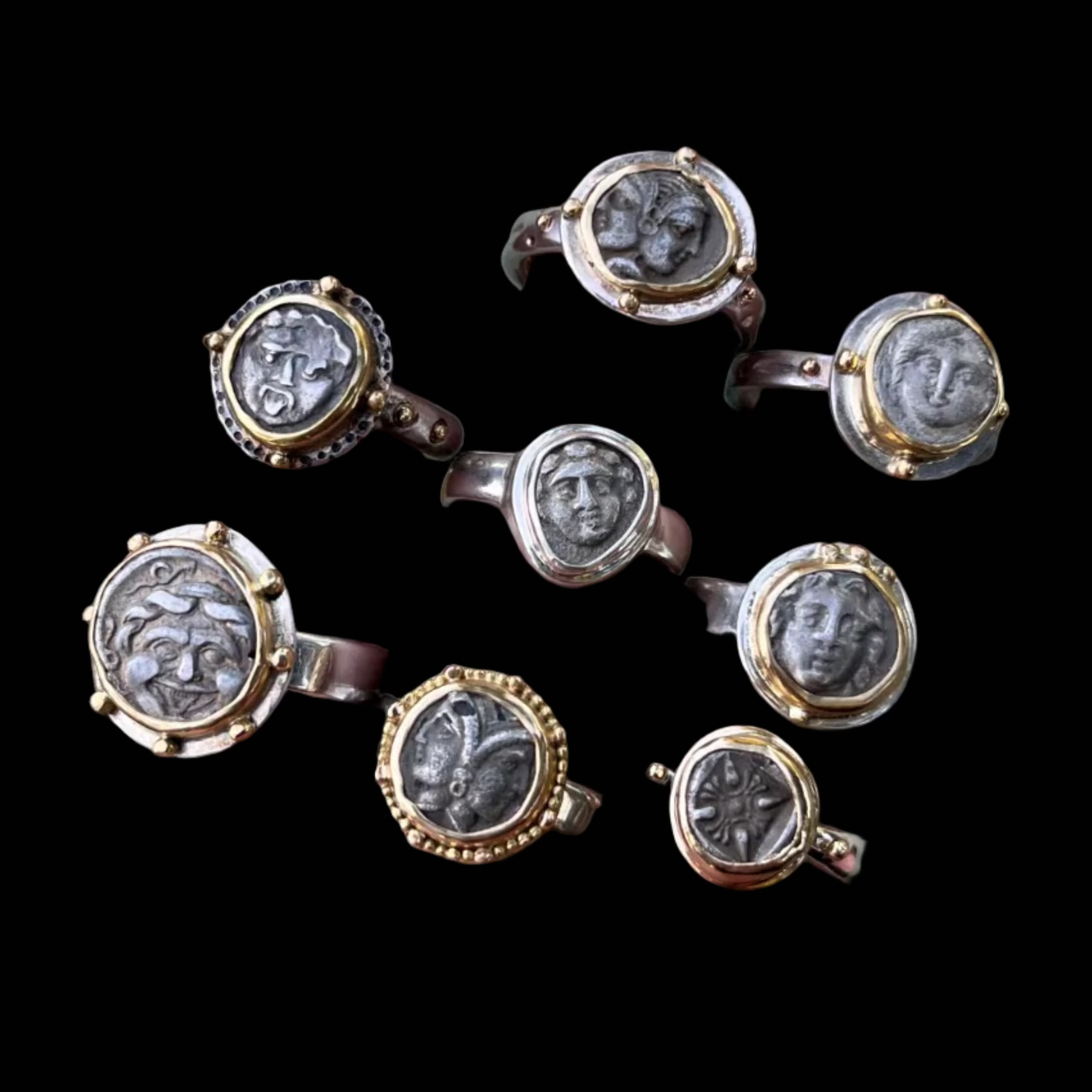 Multiple rings with classical portrait designs on a black background