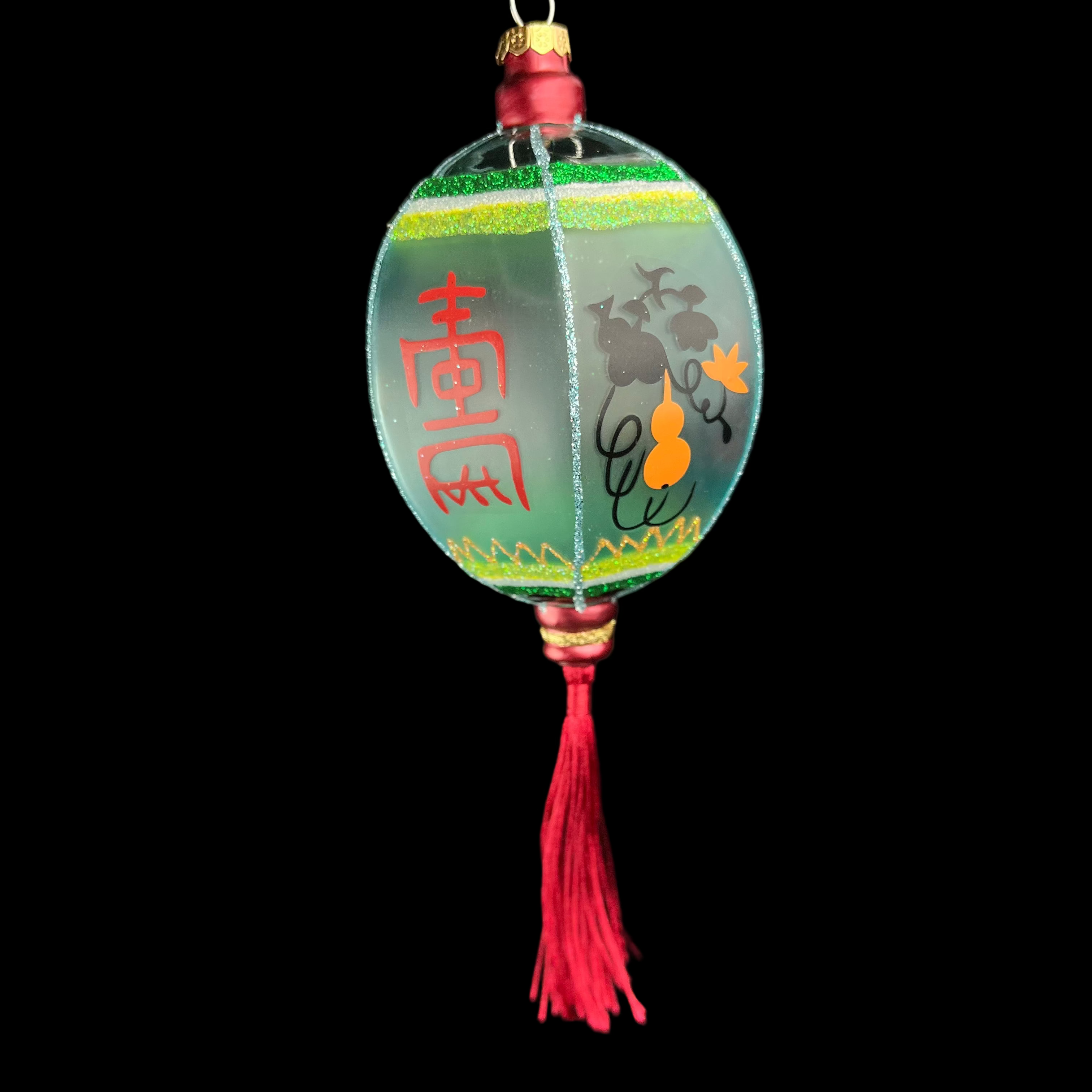 Decorative lantern with Chinese characters and tassel on a black background