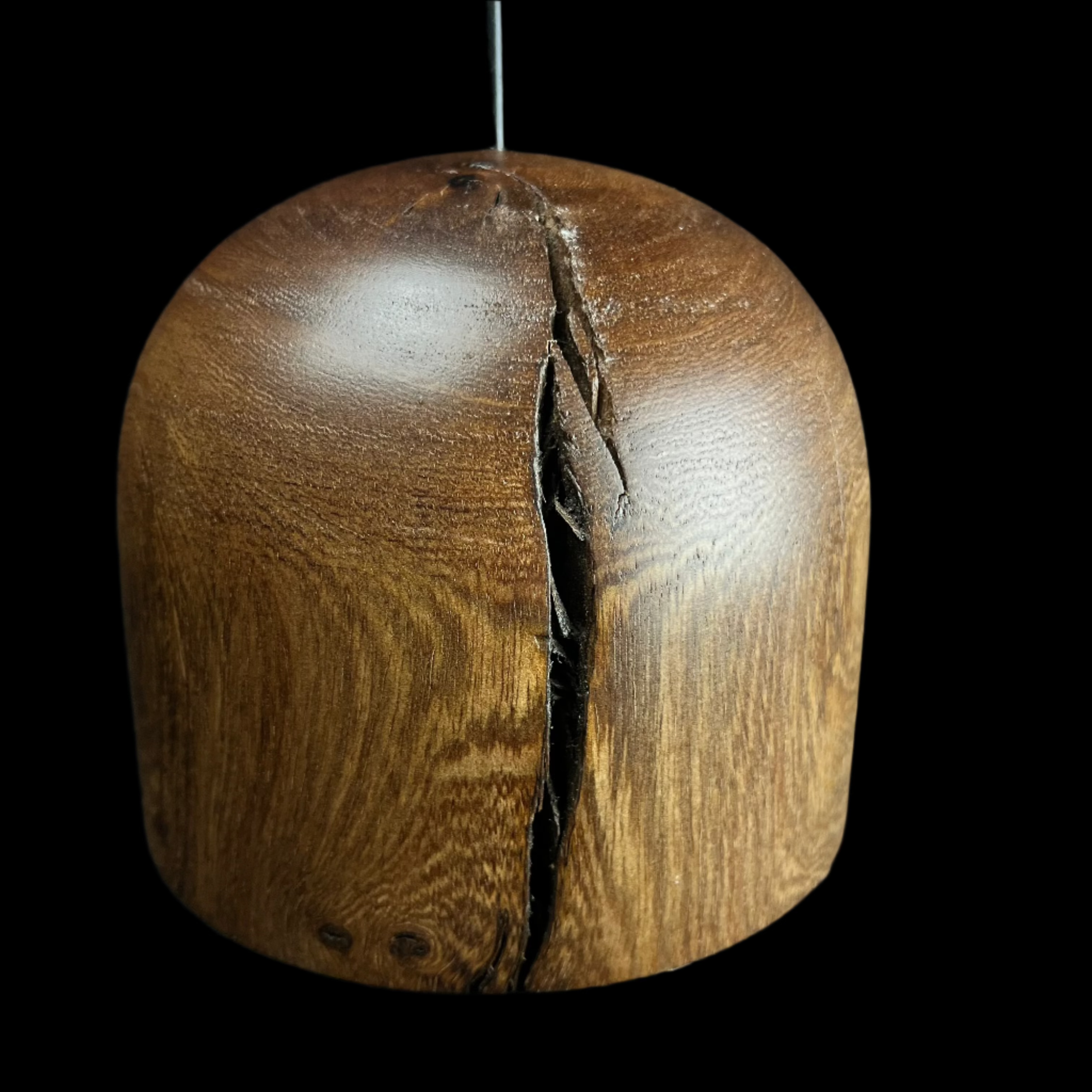 Wooden ball with a crack on a black background