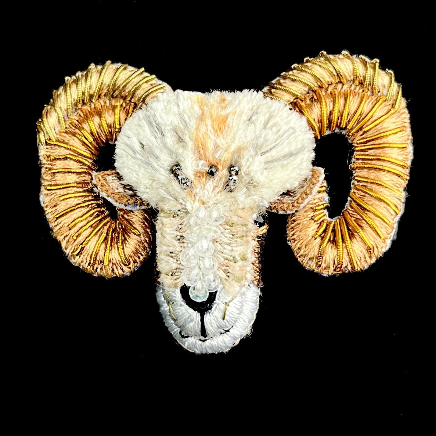 White fluffy embroidered sheep head with large golden horns