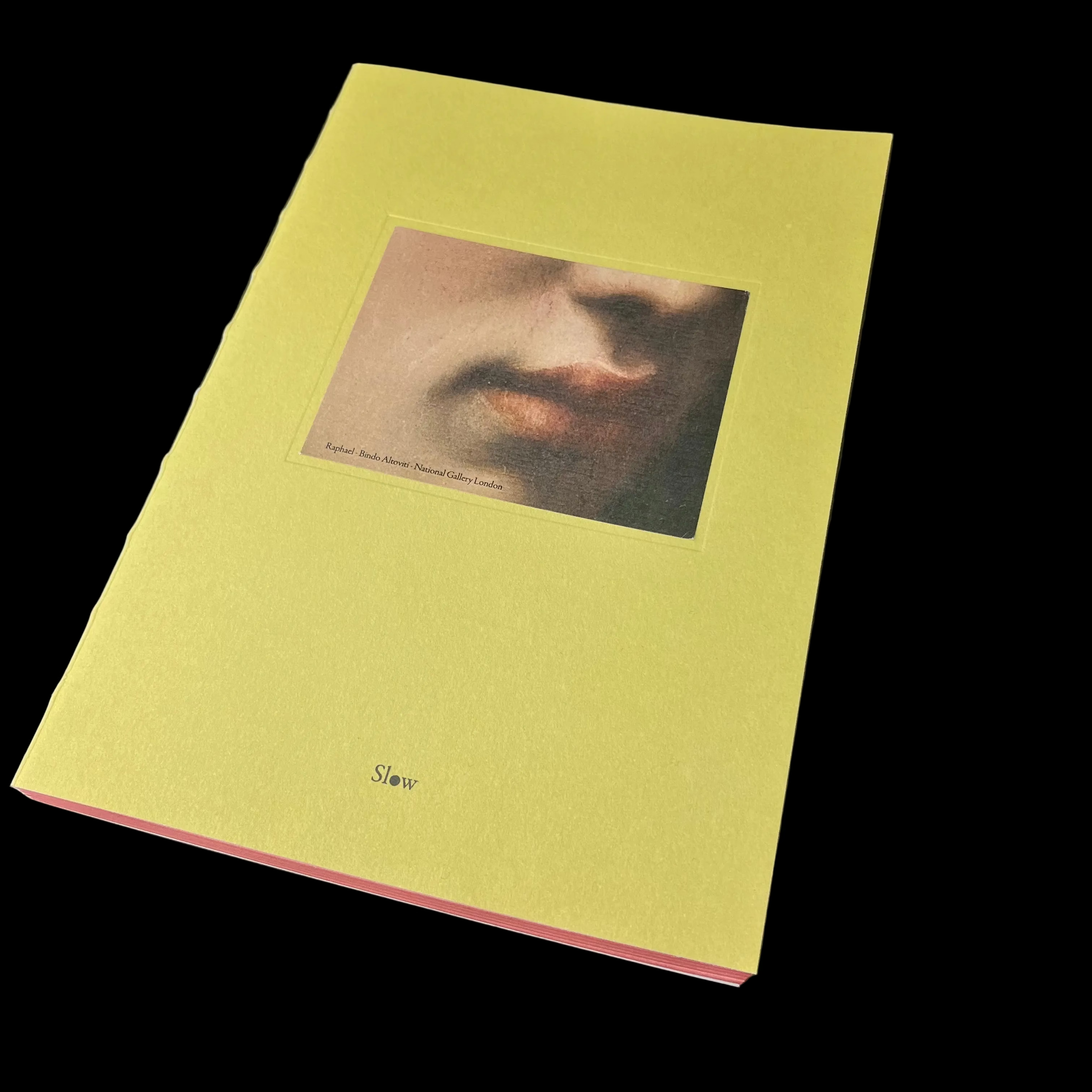 Yellow book with a portrait on the cover against a black background