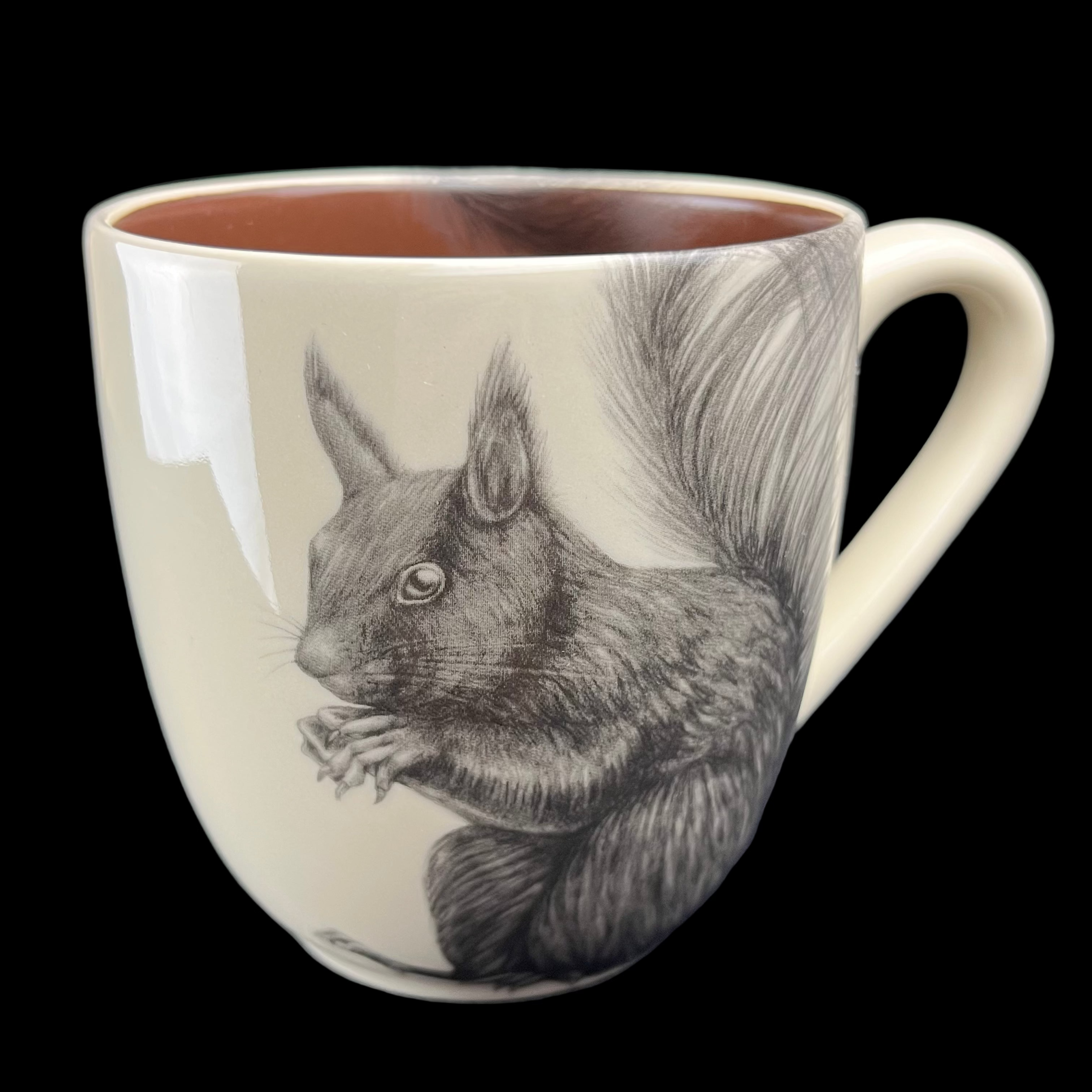 Mug with a squirrel design on a dark surface