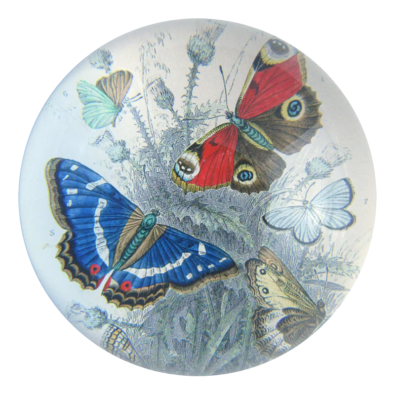 Decorative round paperweight with colorful butterflies on a white background