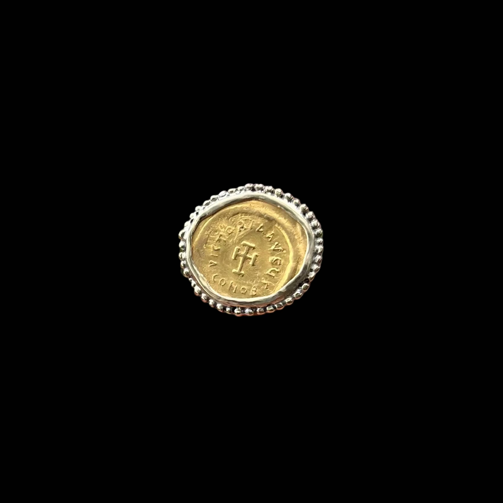 Gold Coin with ornate boarder shown on black background