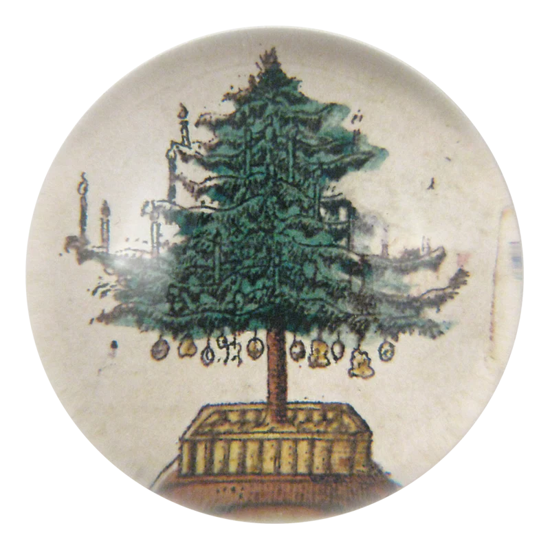 Decorative button with a Christmas tree design on a white background