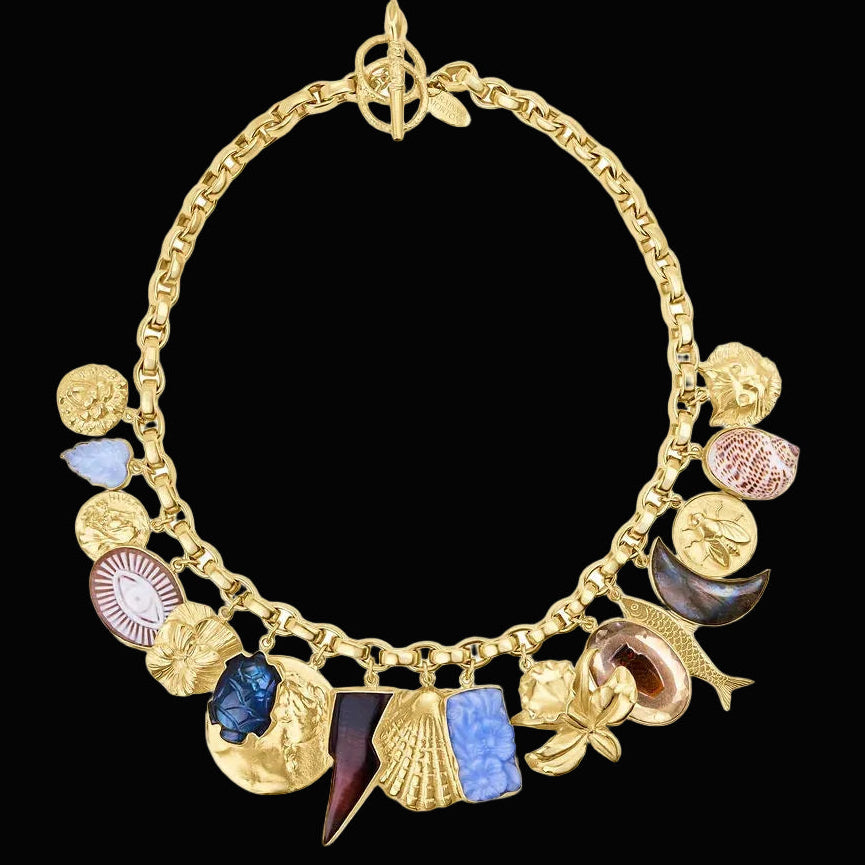 alternating solid gold charms with stones of different shapes and colors appearing to be found from vintage jewelry on large link gold chain with long toggle closure 
