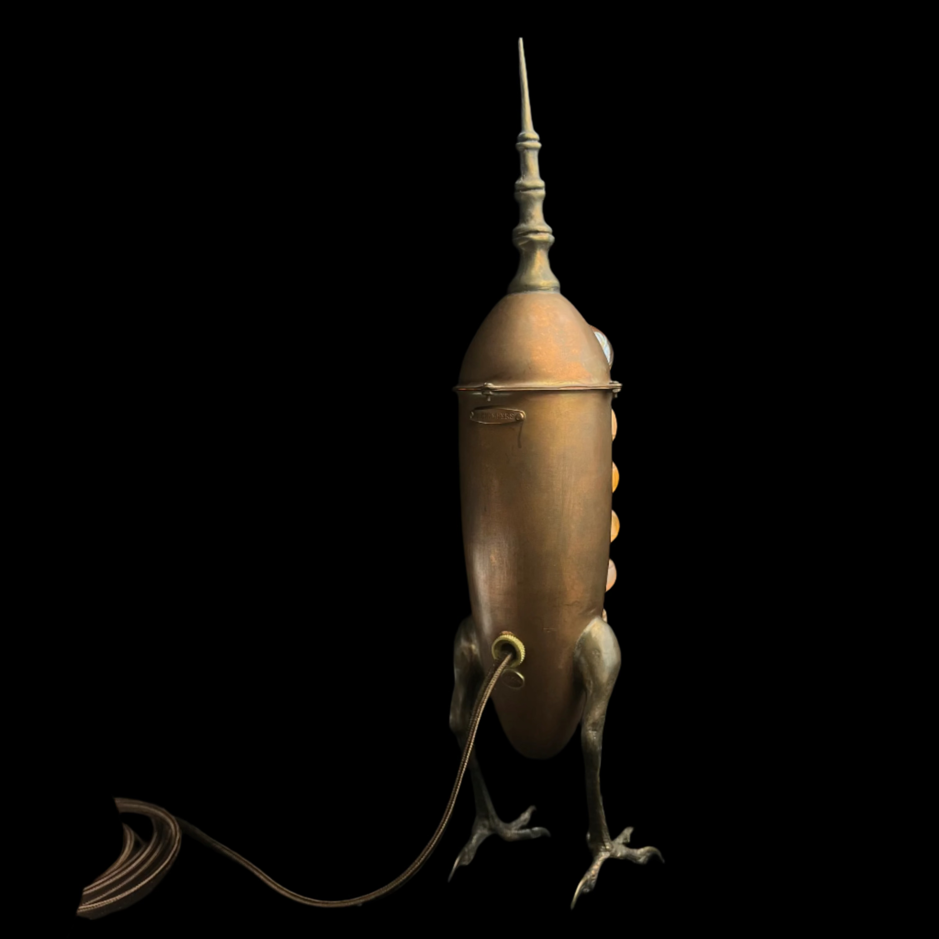 Bronze dragon-shaped lamp on a black background
